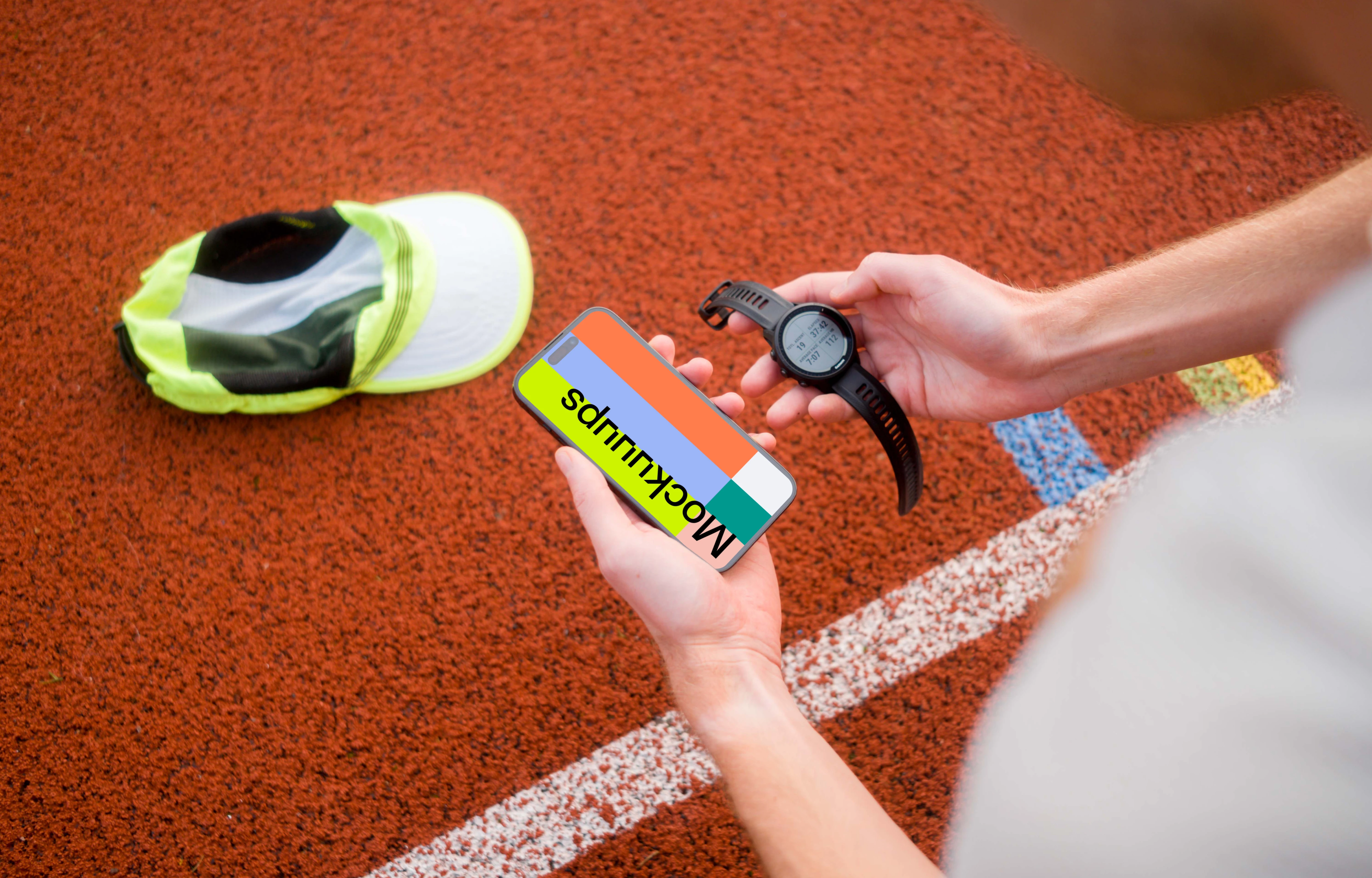 Runner holding sport watches and iPhone 14 Pro mockup