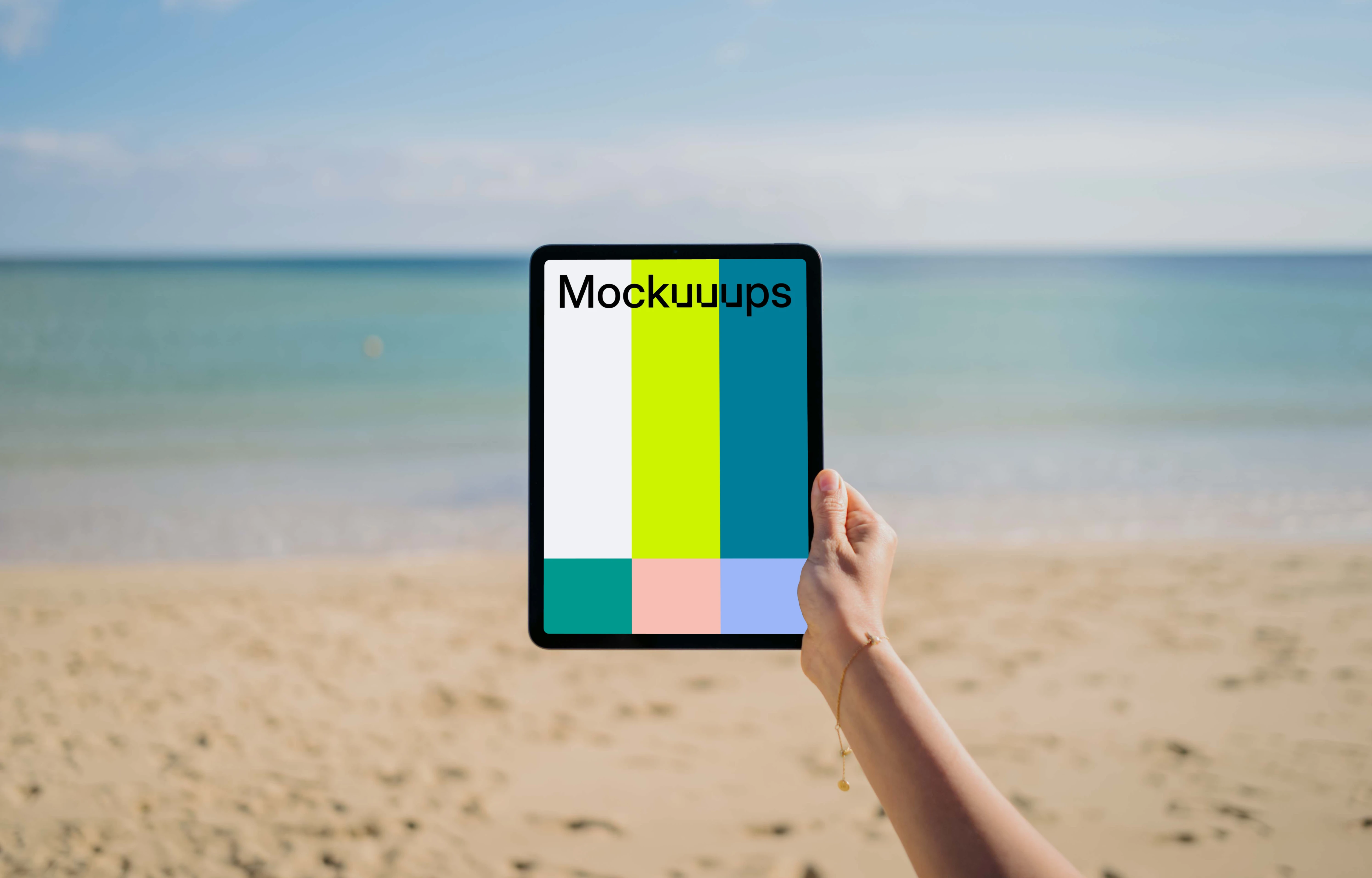 iPad Air mockup held by user at the beach 