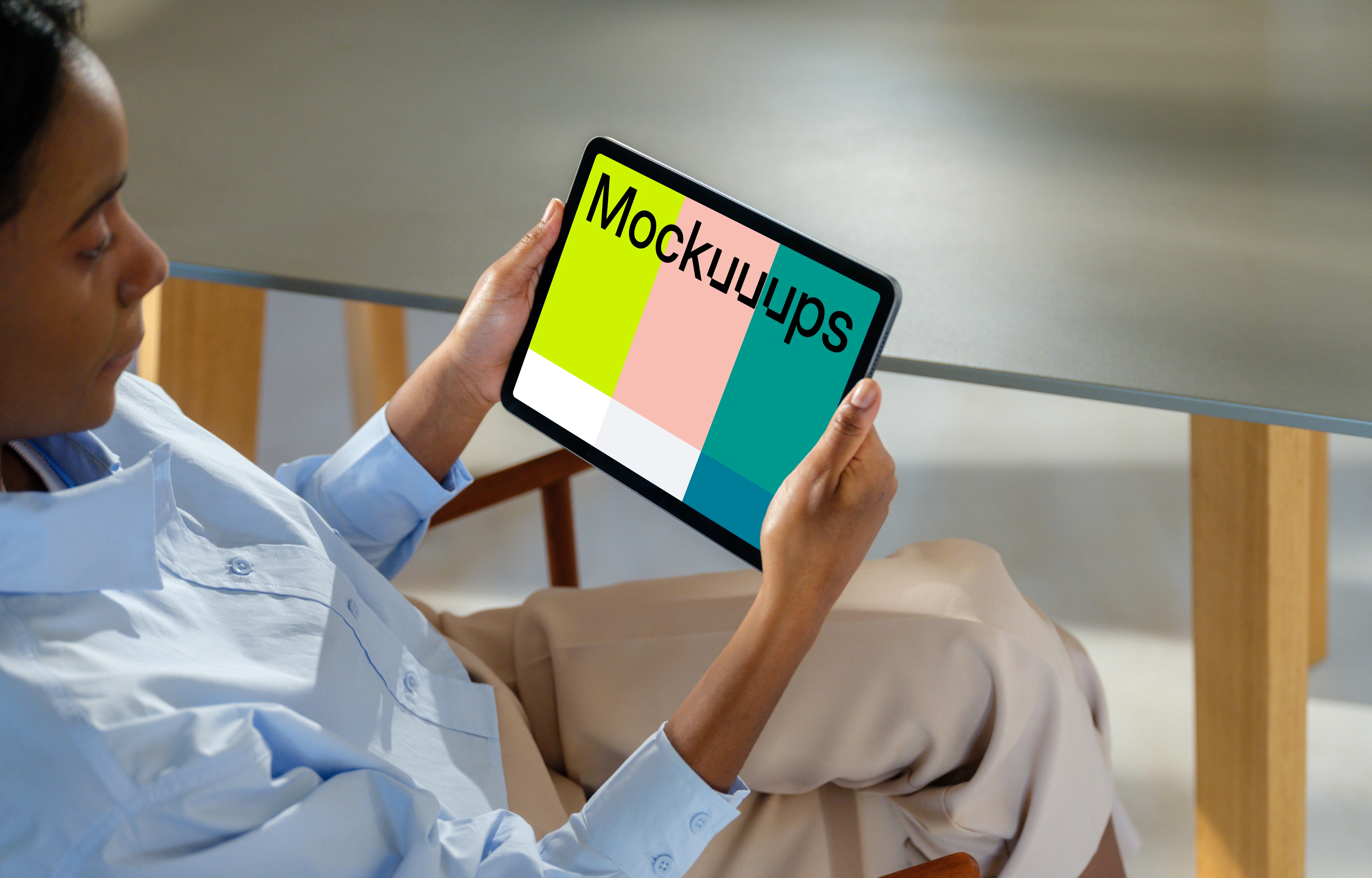 iPad Air mockup in a woman's hand at a modern office