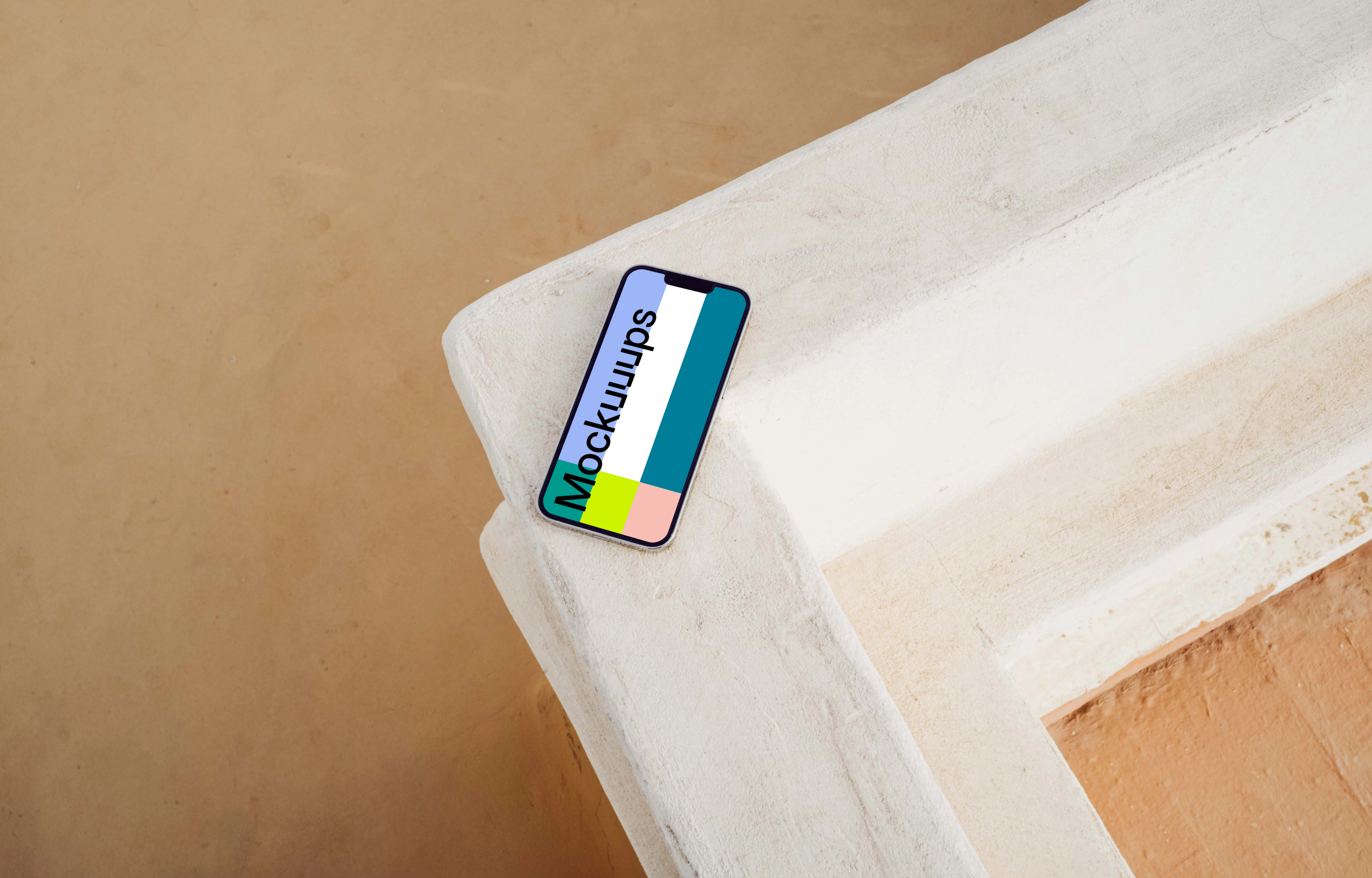 iPhone 13 Pro mockup beside a brown wall