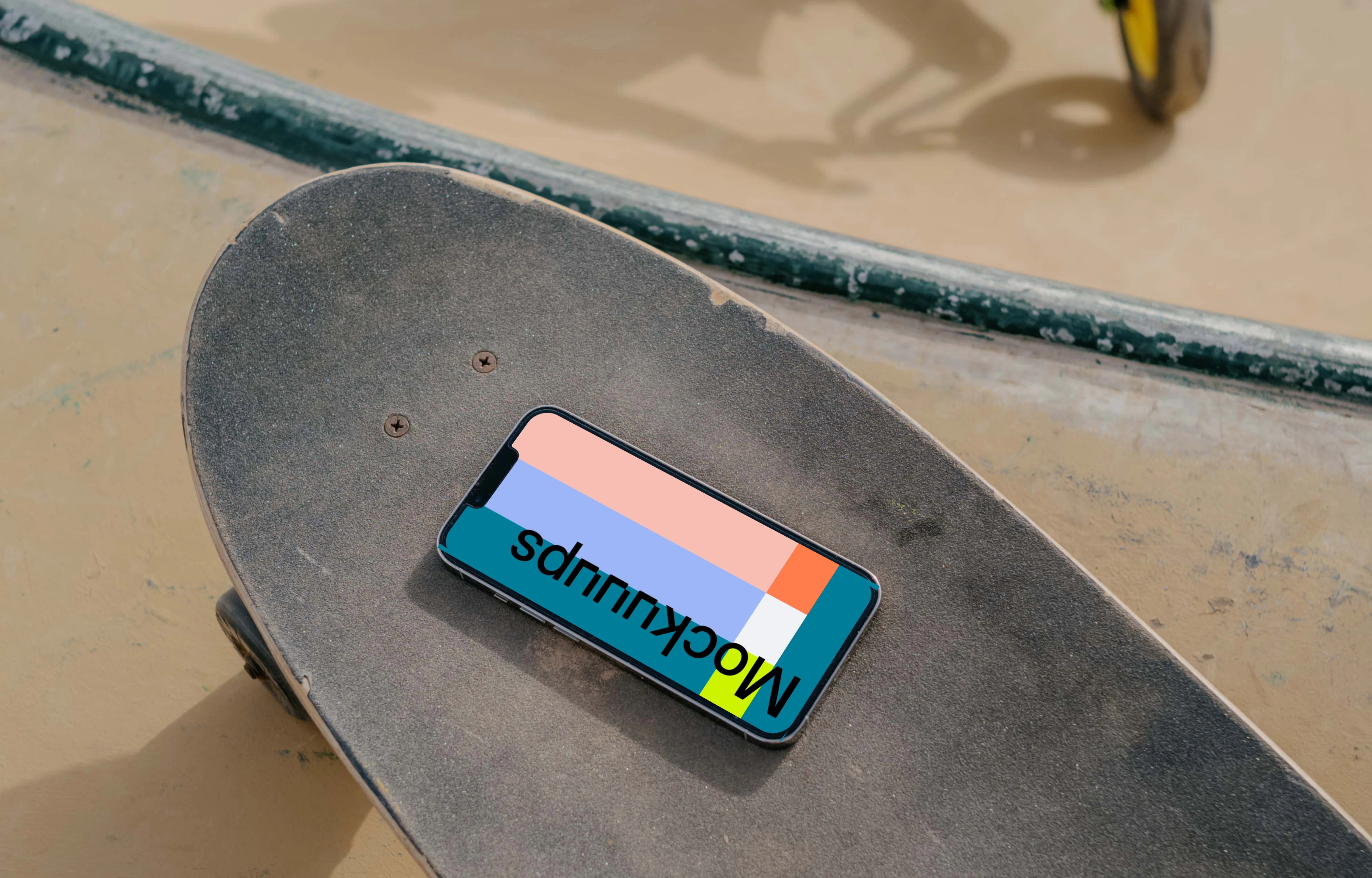  iPhone 13 Pro mockup on a skateboard