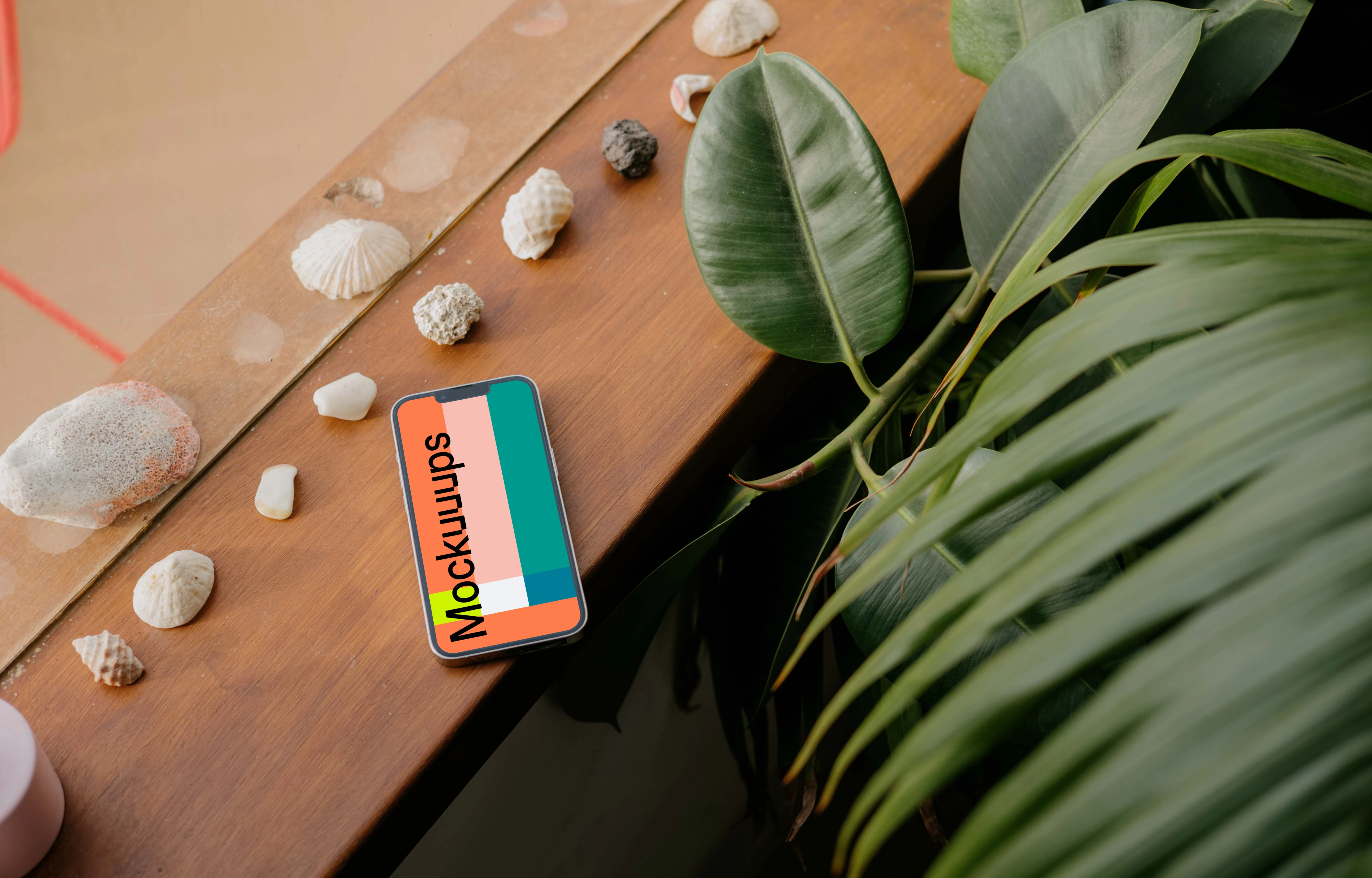  iPhone 13 Pro mockup placed next to seashells