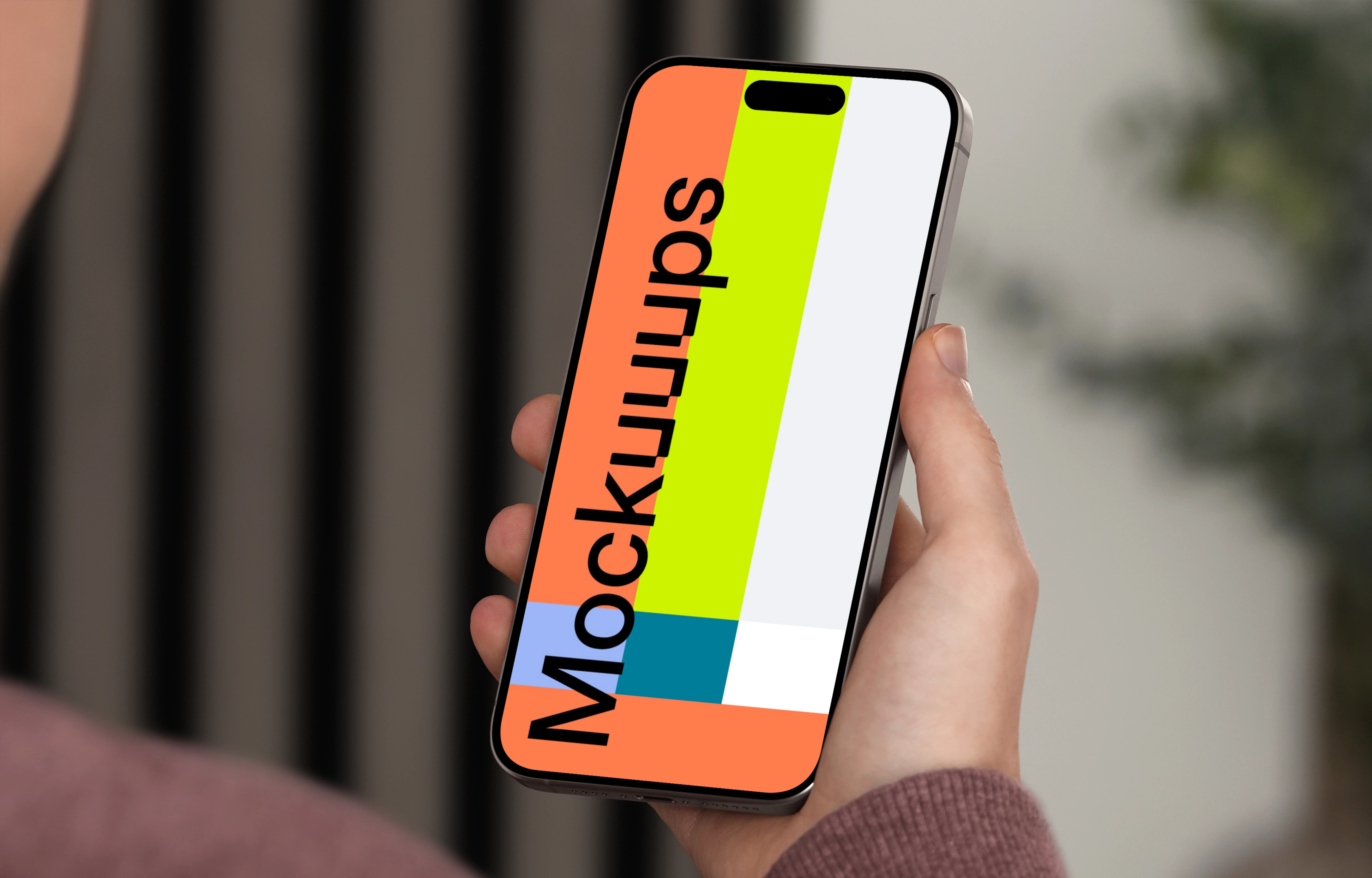 iPhone 15 Pro mockup in a man's hand against an indoor background