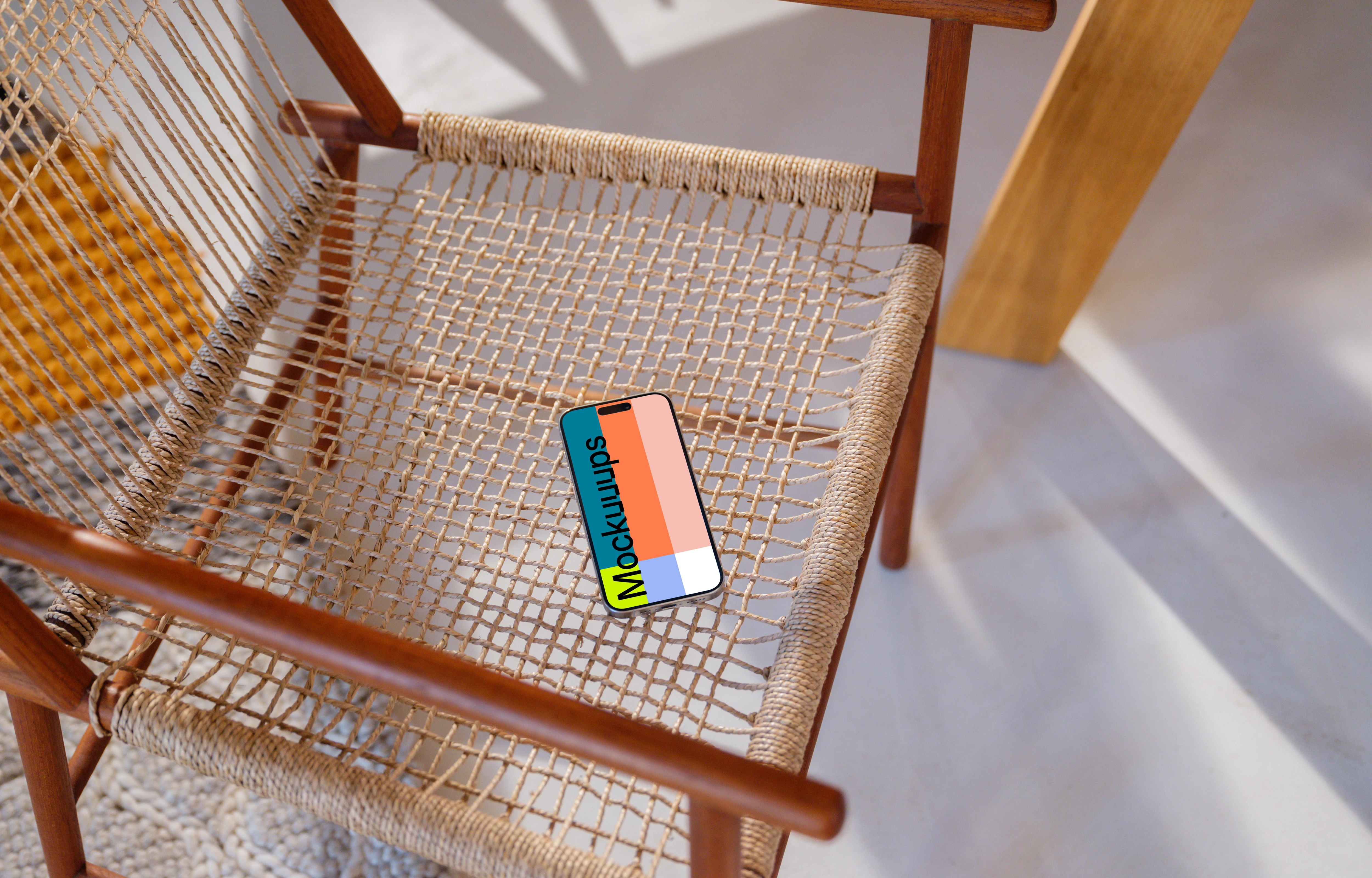 iPhone 15 Pro mockup on a modern woven chair