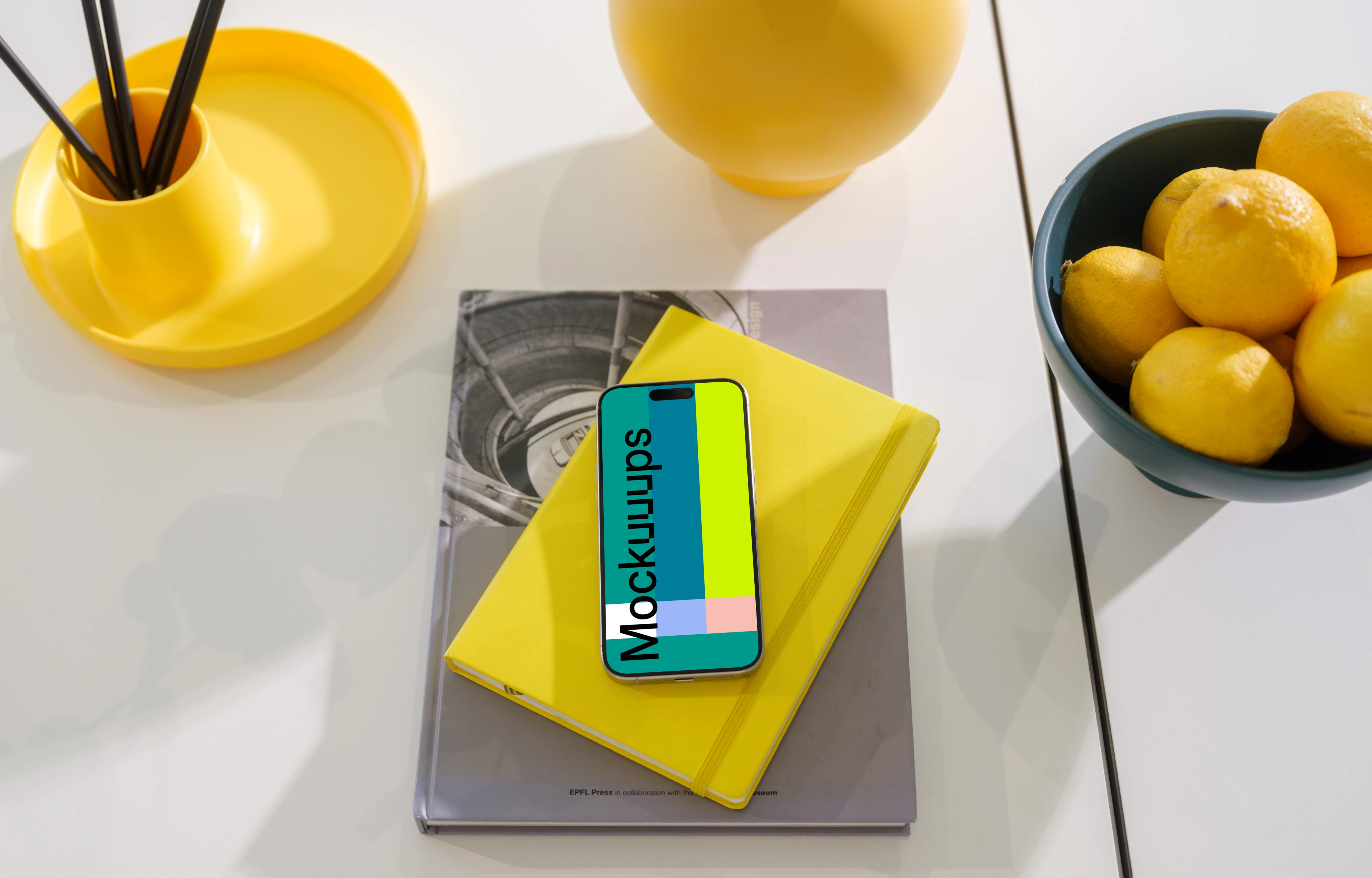 iPhone 15 Pro mockup on a vibrant yellow notebook