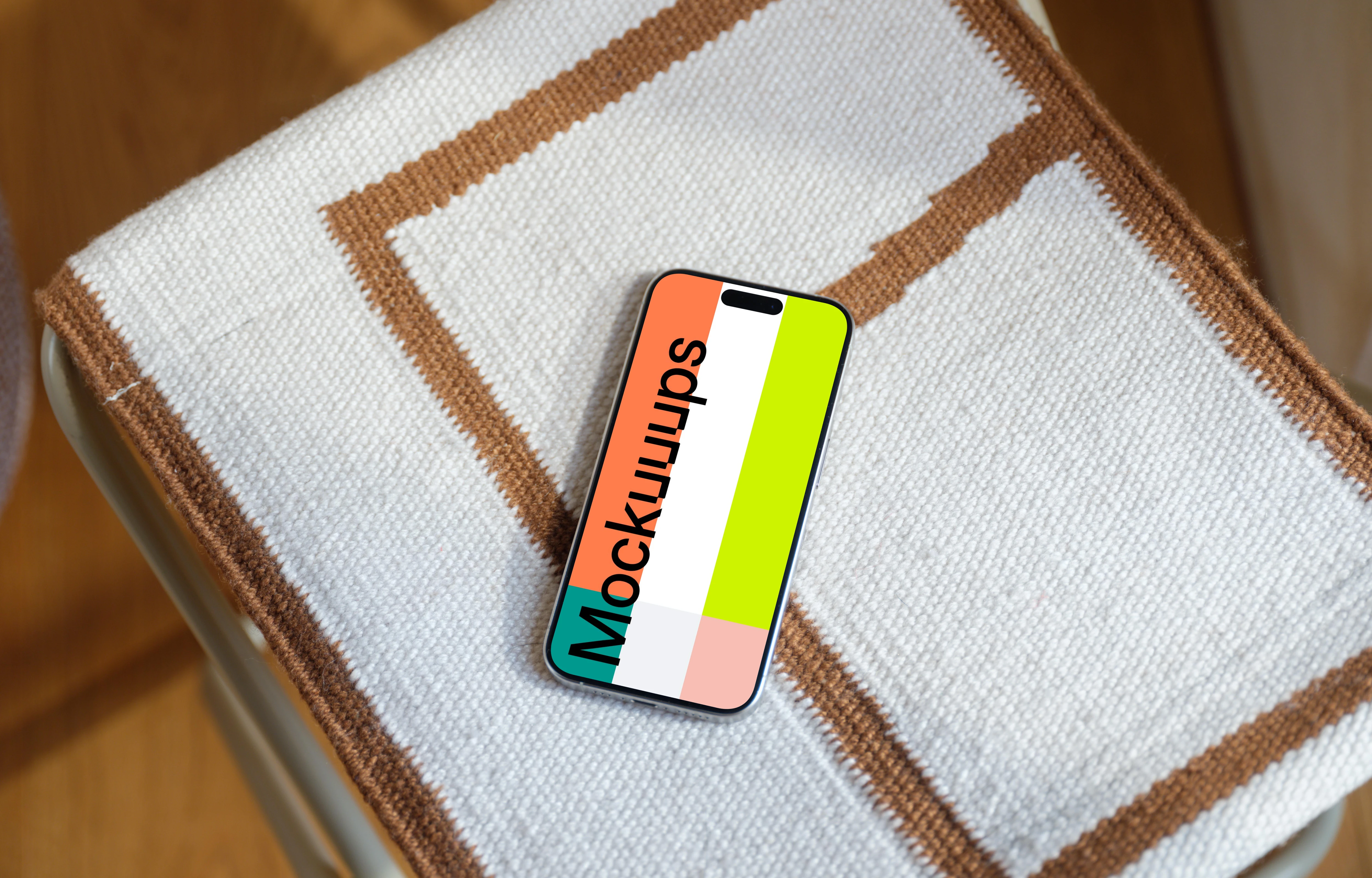 iPhone 15 Pro mockup on textured fabric chair