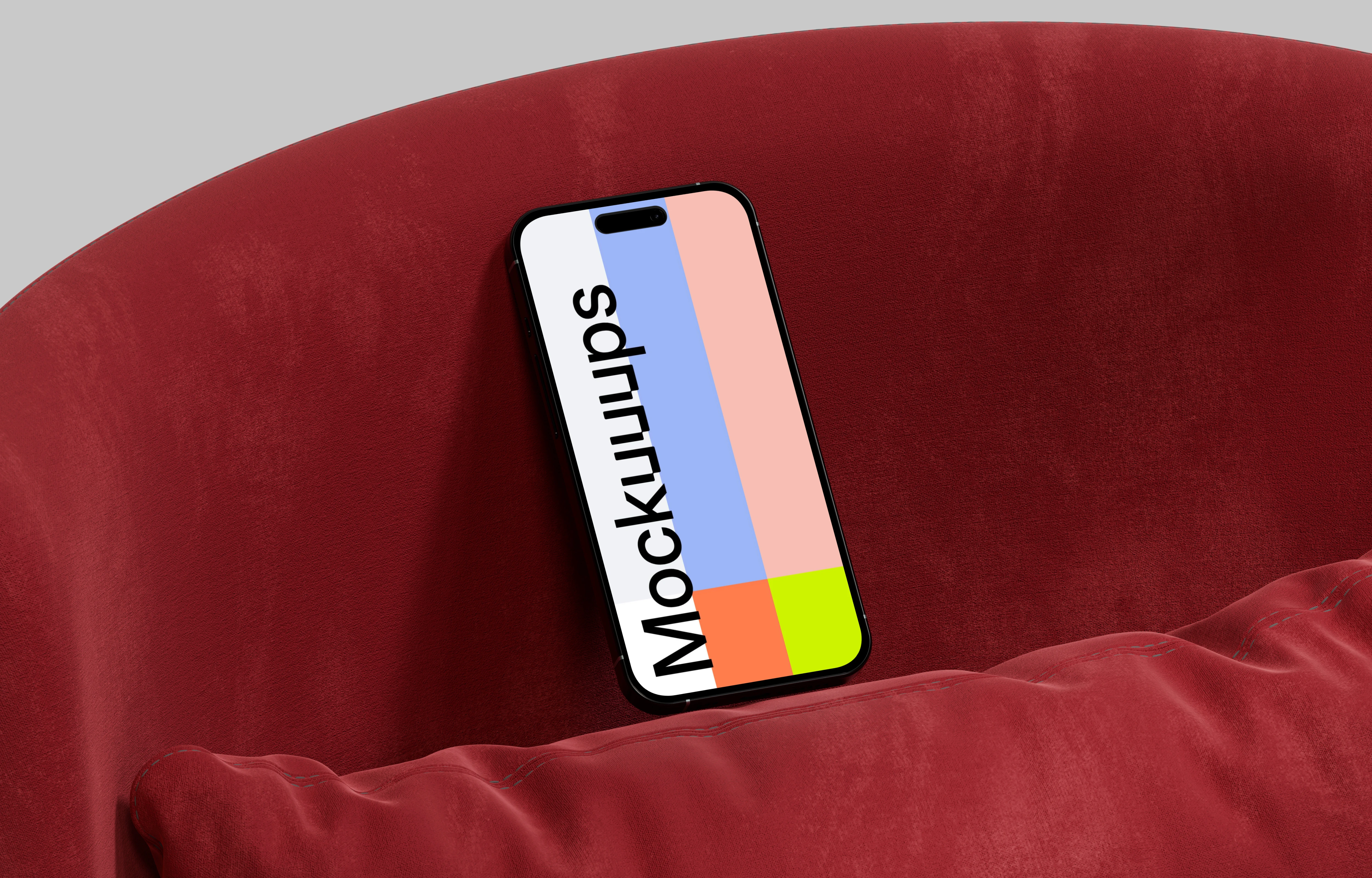 iPhone 16 mockup against a red cushion