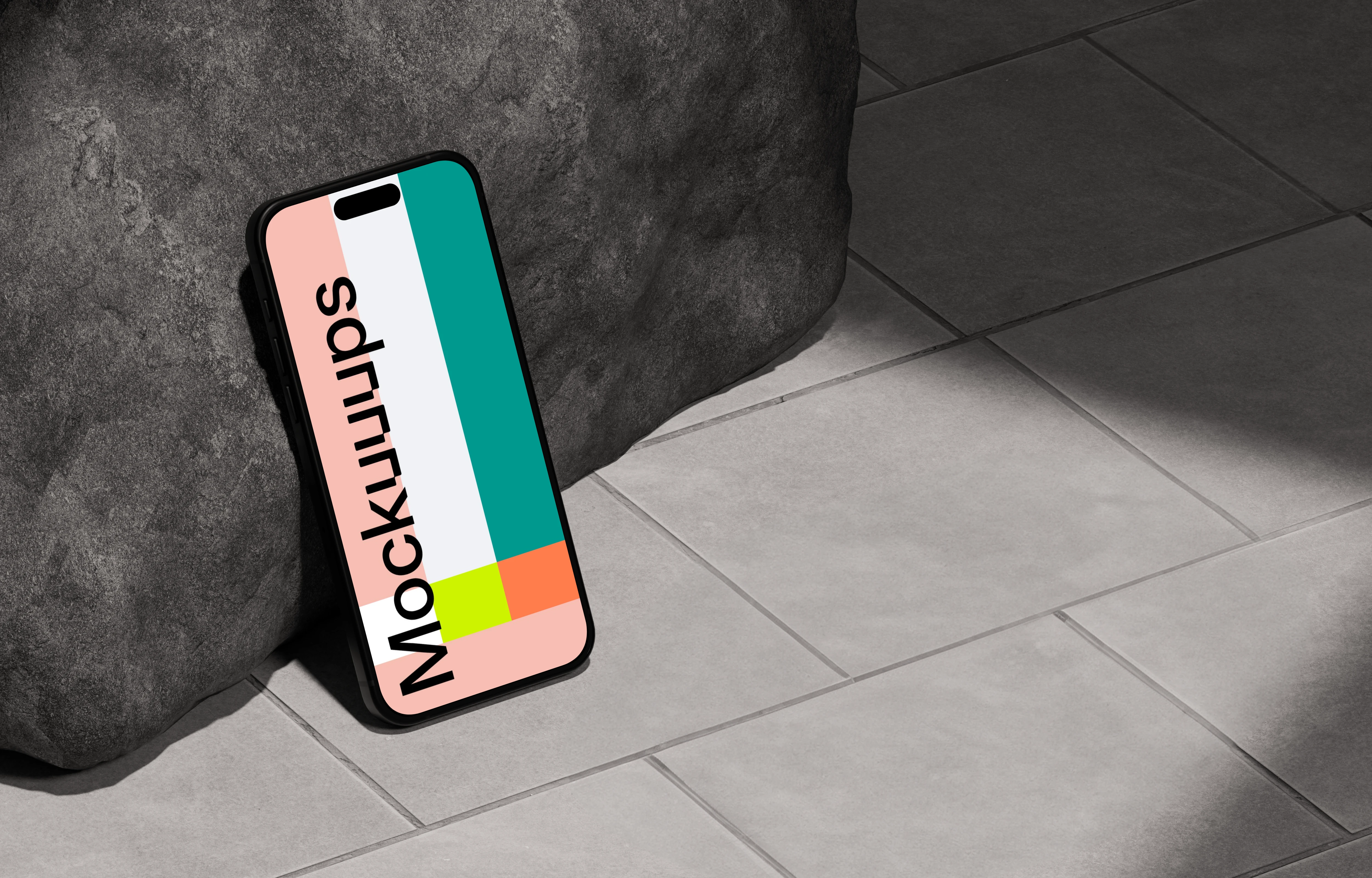 iPhone 16 mockup leaning against a rock on tiled floor