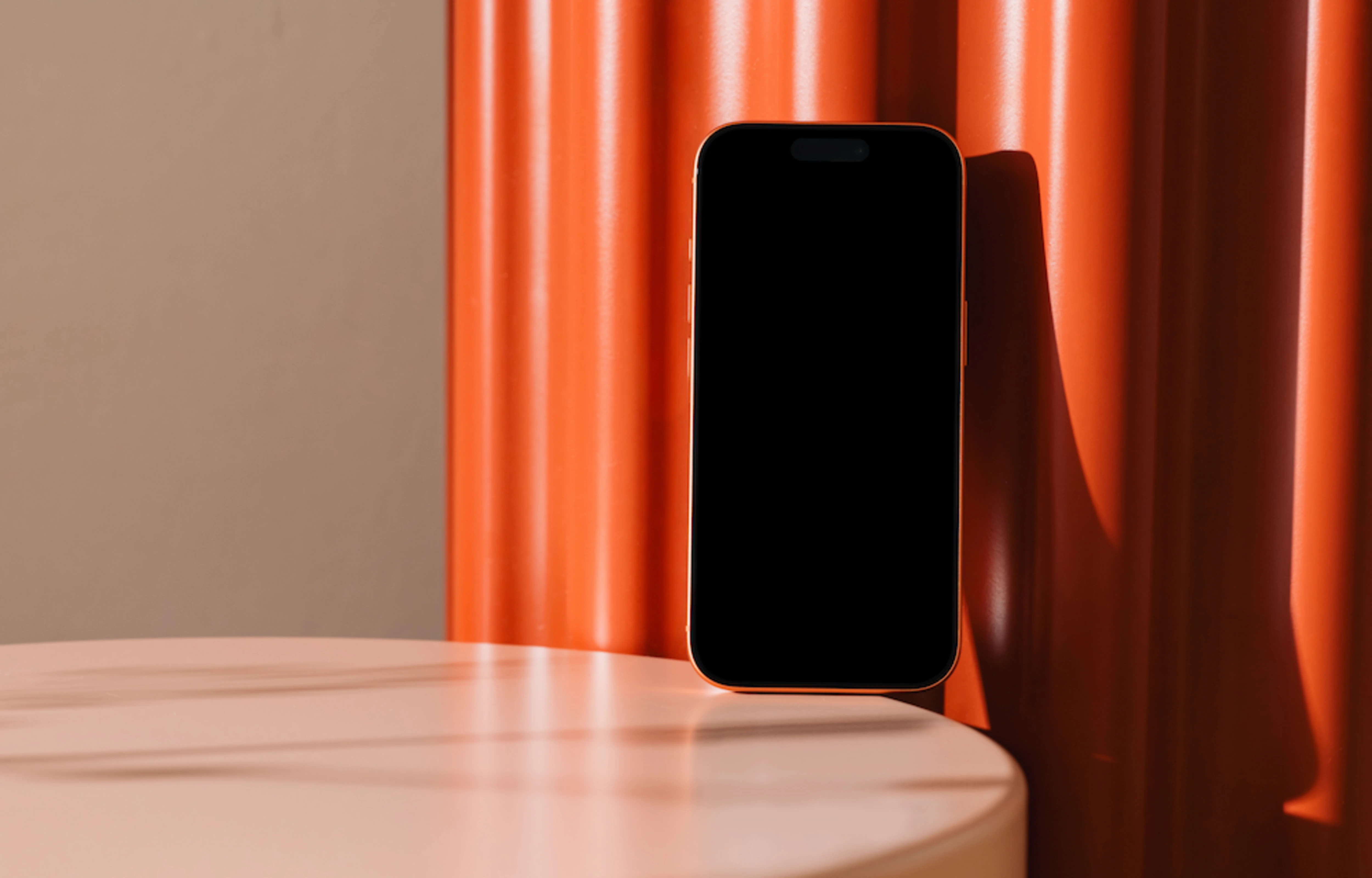 iPhone 17 Pro mockup against orange background