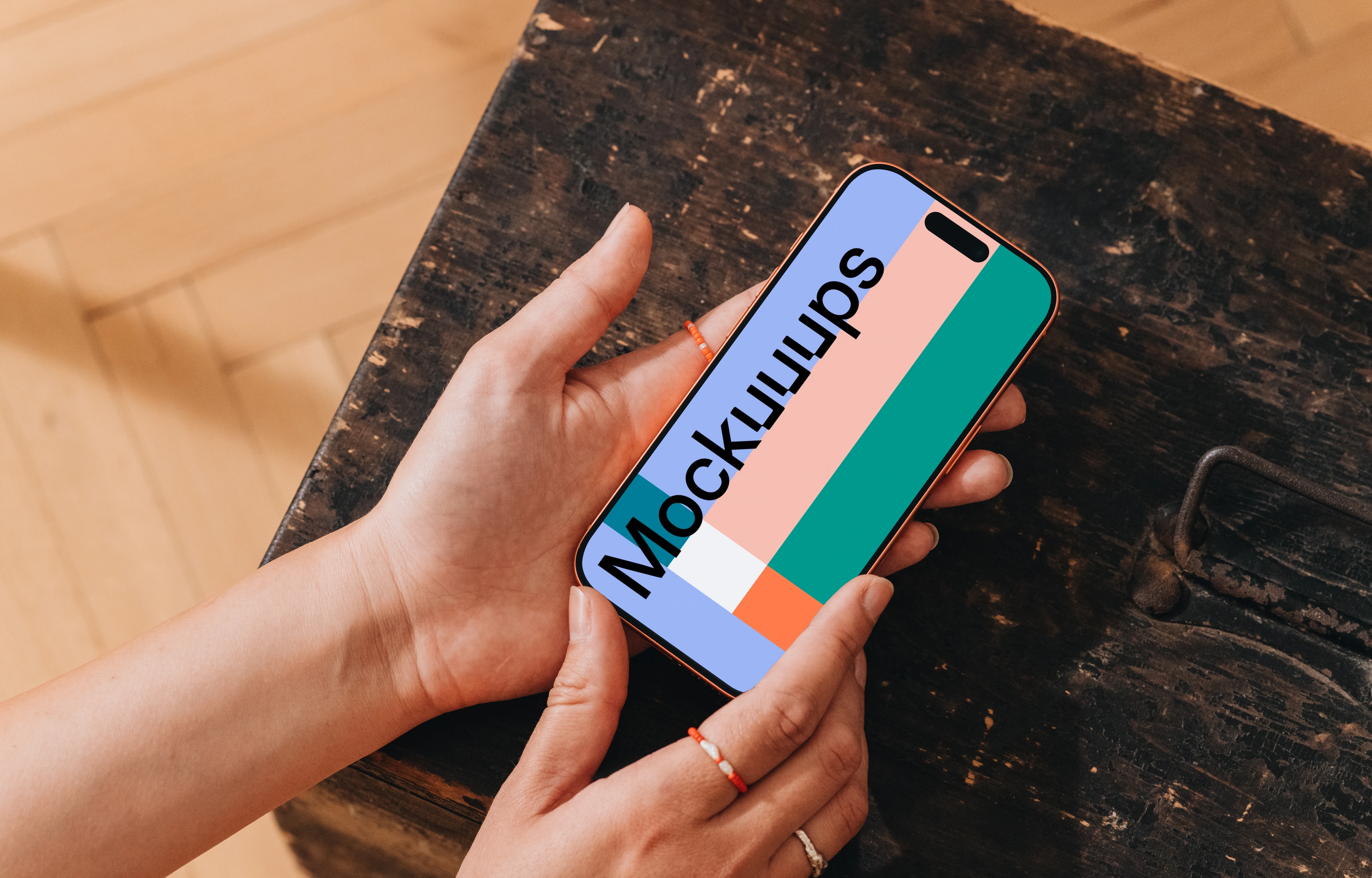 iPhone 17 Pro mockup held over a rustic table