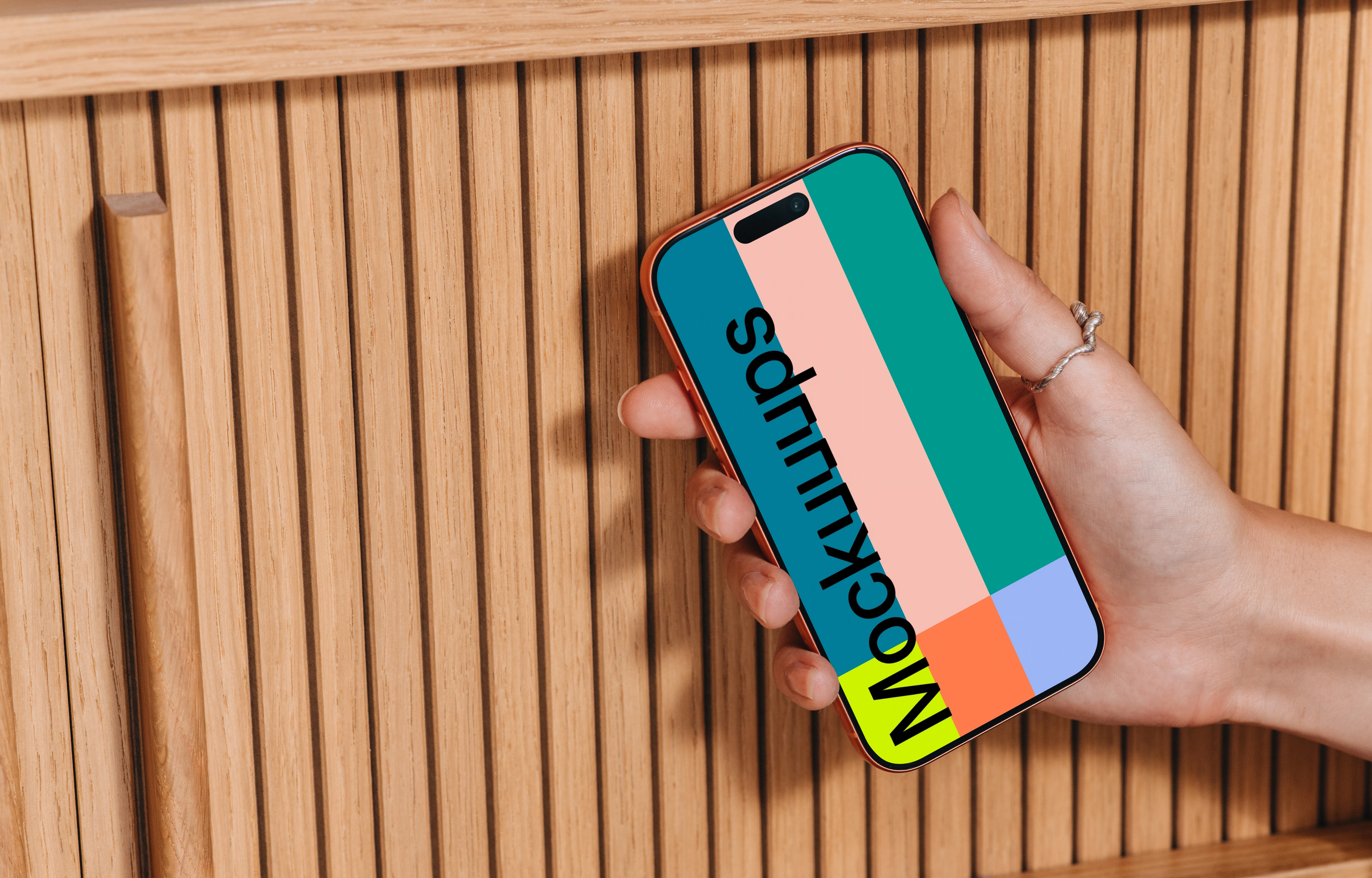 iPhone 17 Pro mockup in a hand near wooden texture