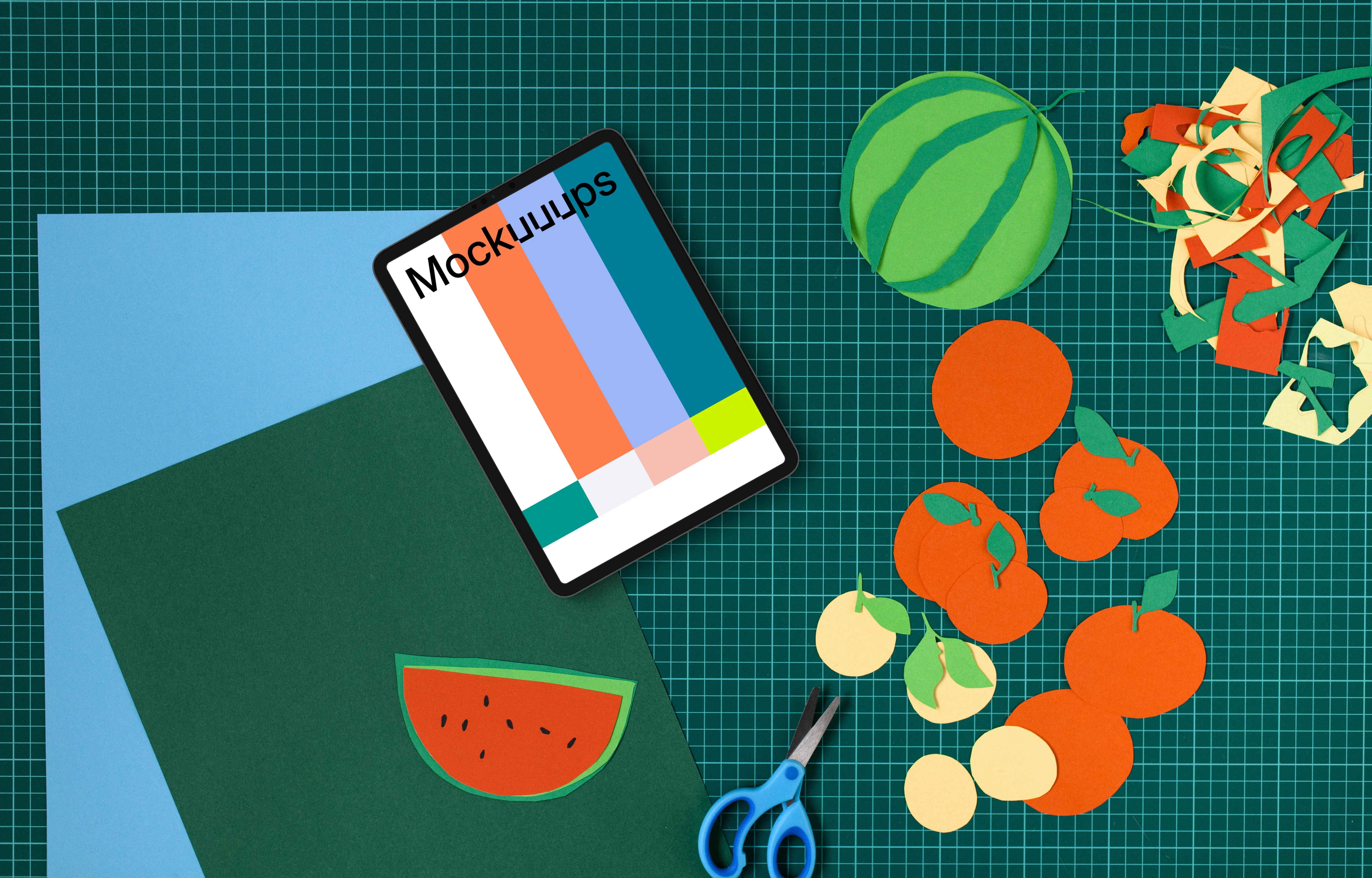 Tablet mockup on a colorful craft table with cut-out fruits