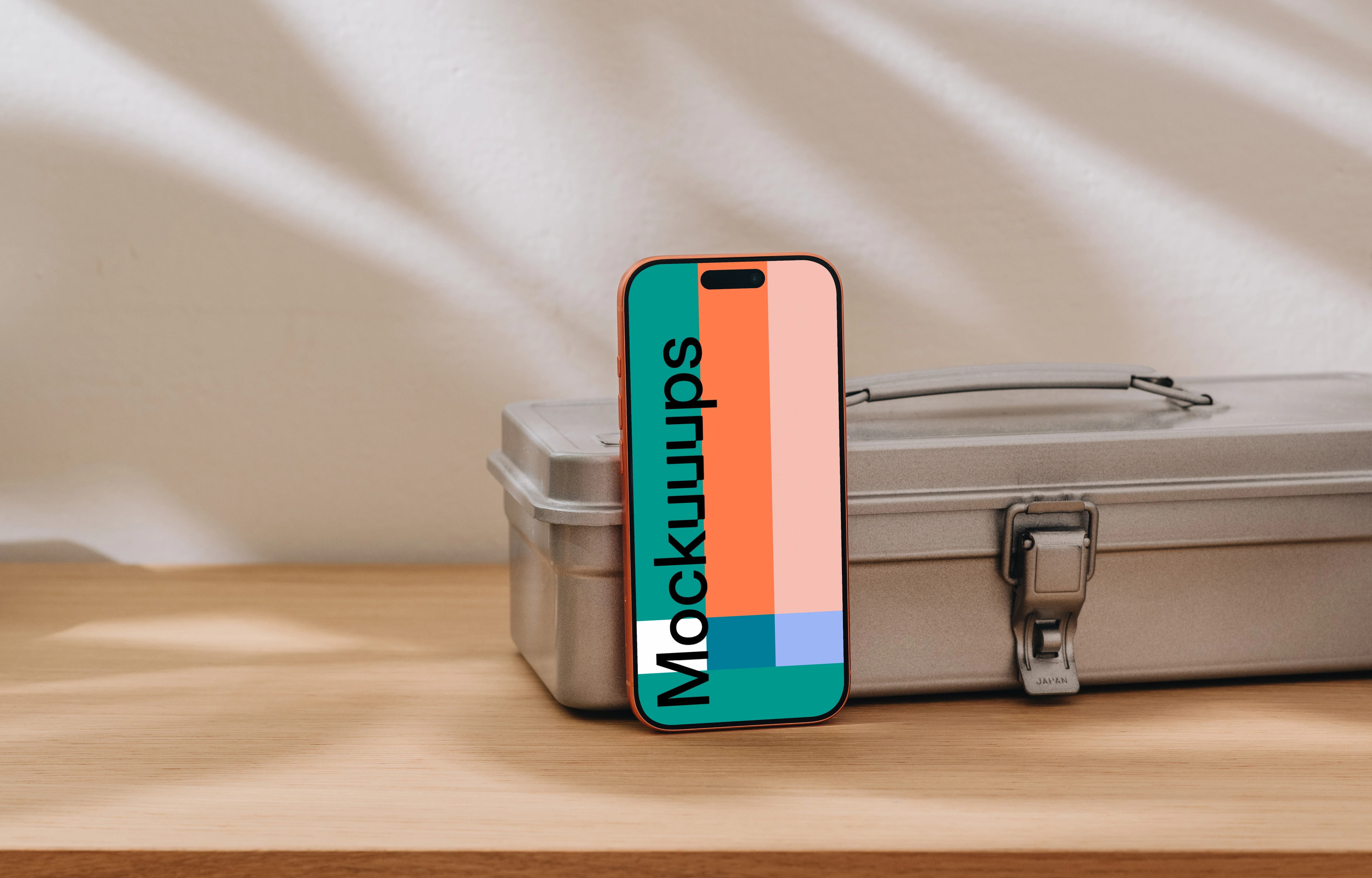 iPhone 17 Pro mockup on a wooden surface with a metal box