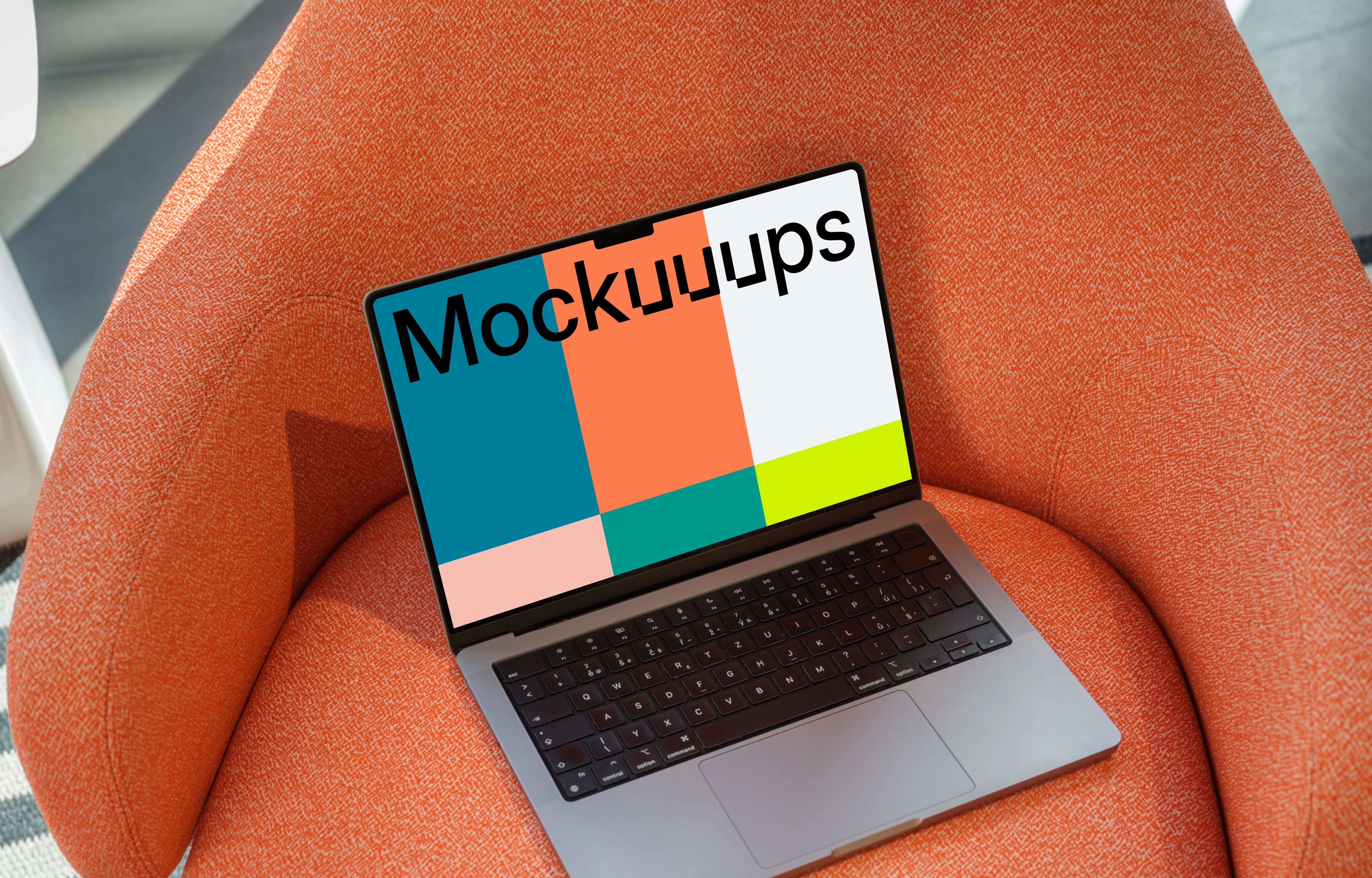 MacBook Pro Mockup on an Orange Textured Armchair