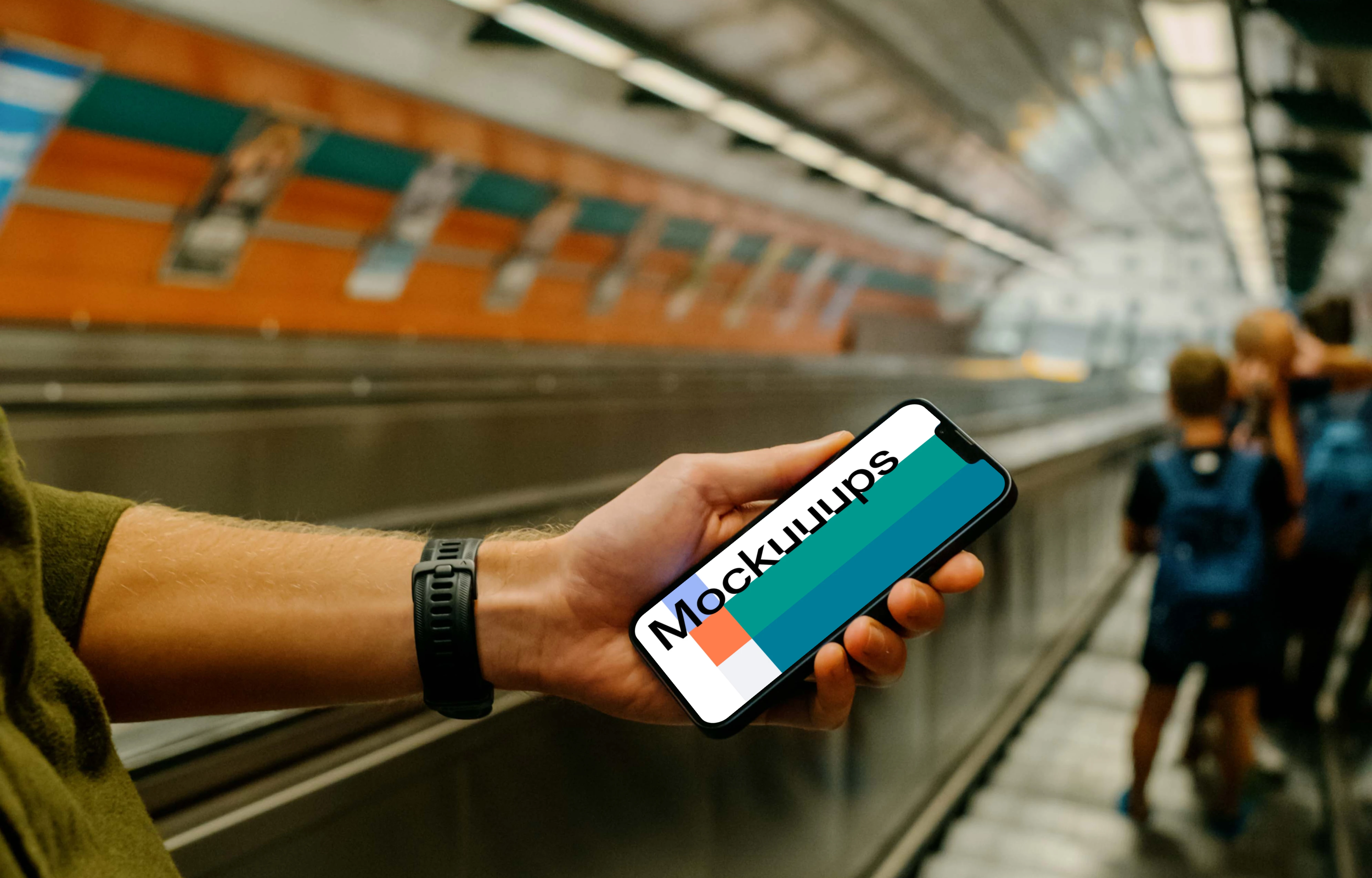 Man holding iPhone 13 mockup in subway