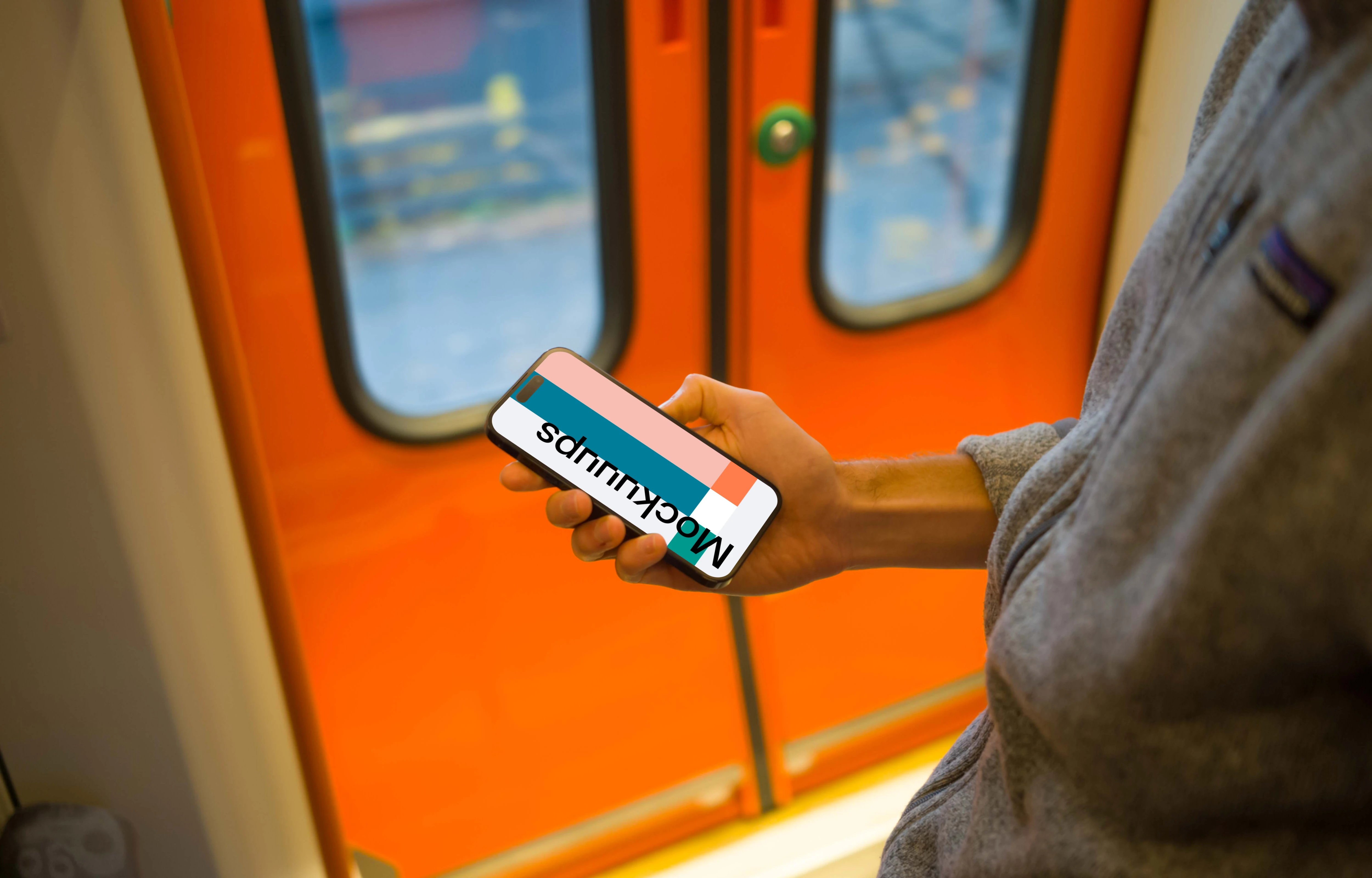 Man holding smartphone on the train