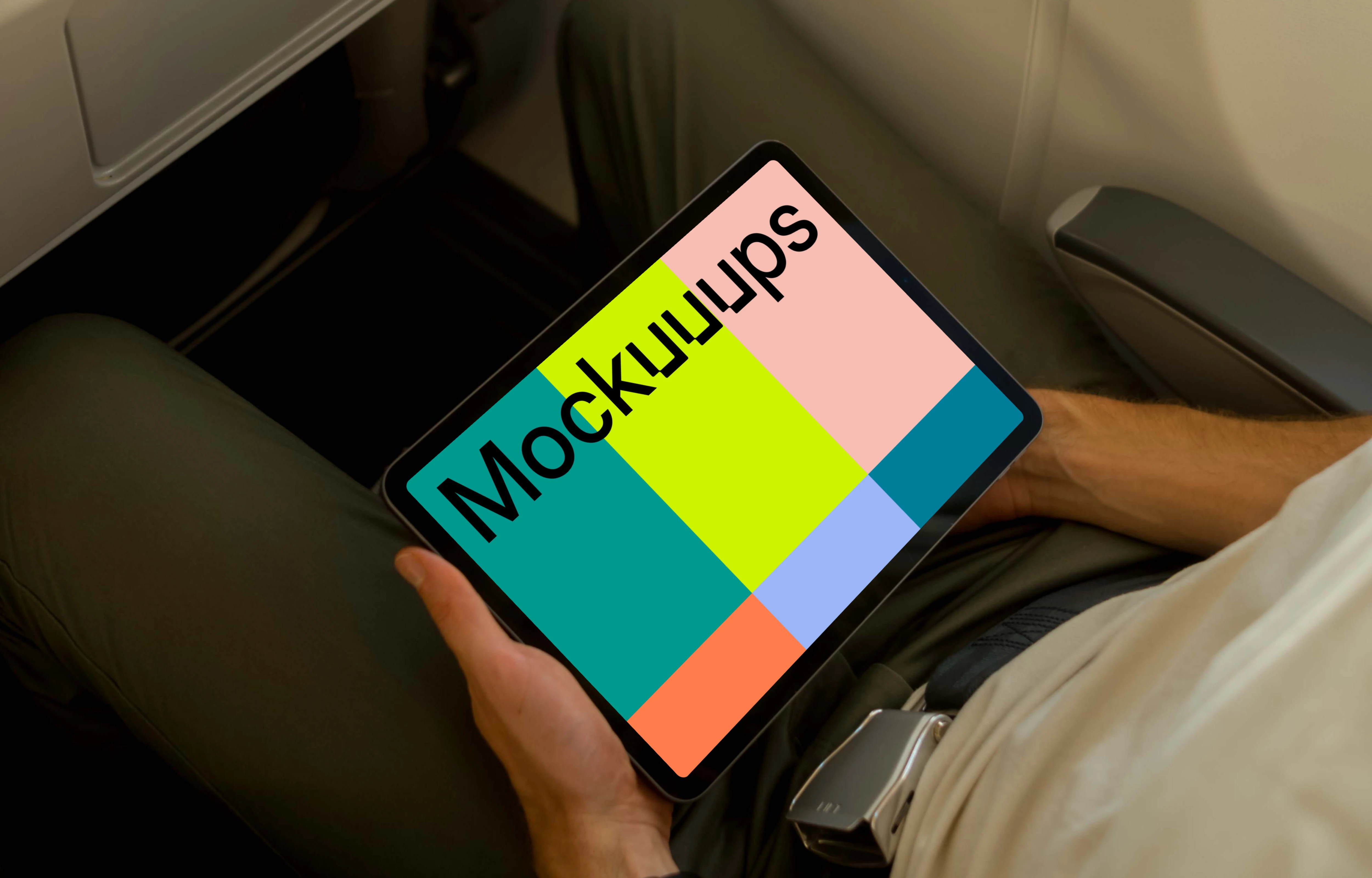 Man using a tablet mockup on an airplane