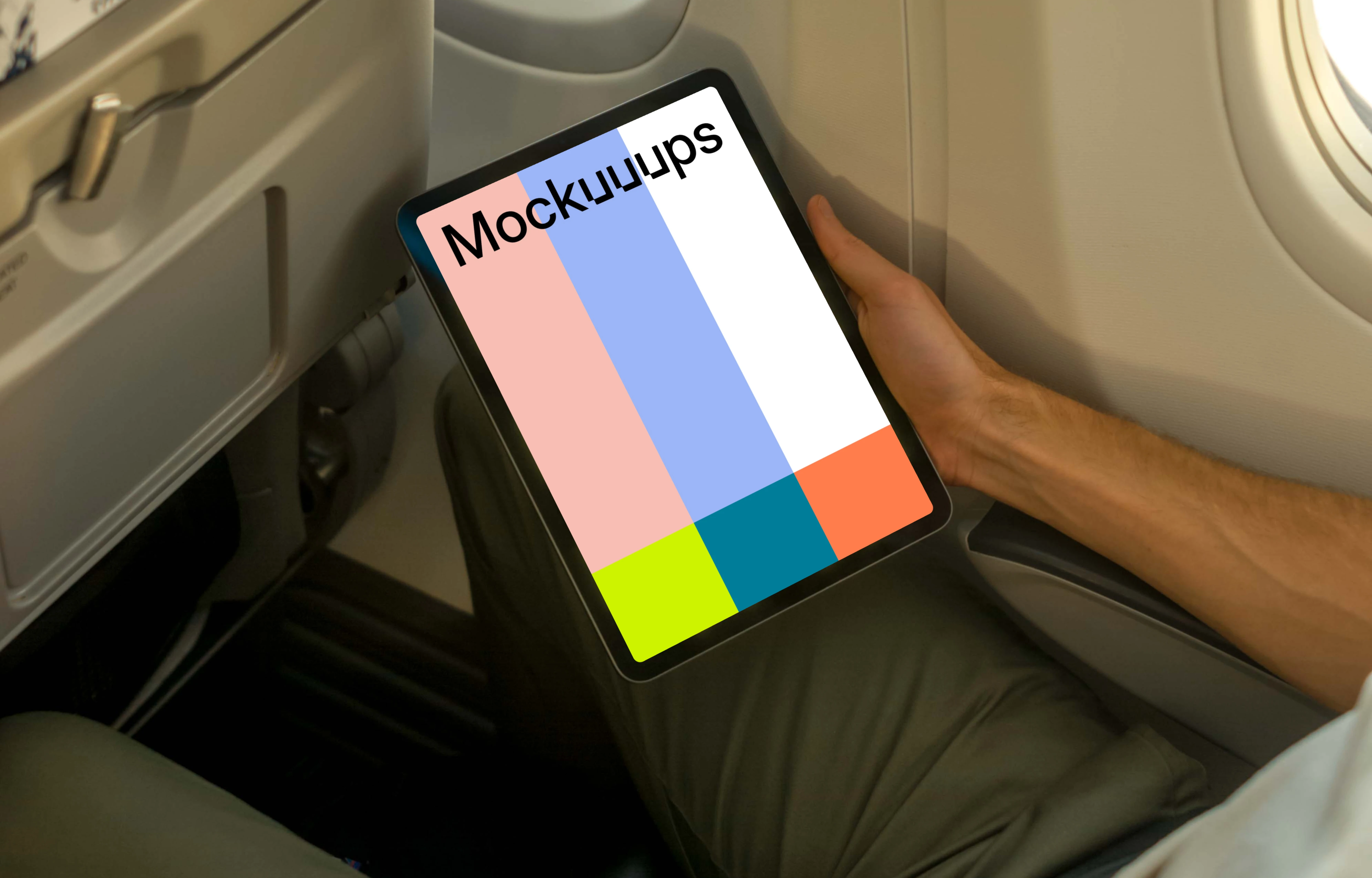 Man using iPad Air mockup while sitting in airplane