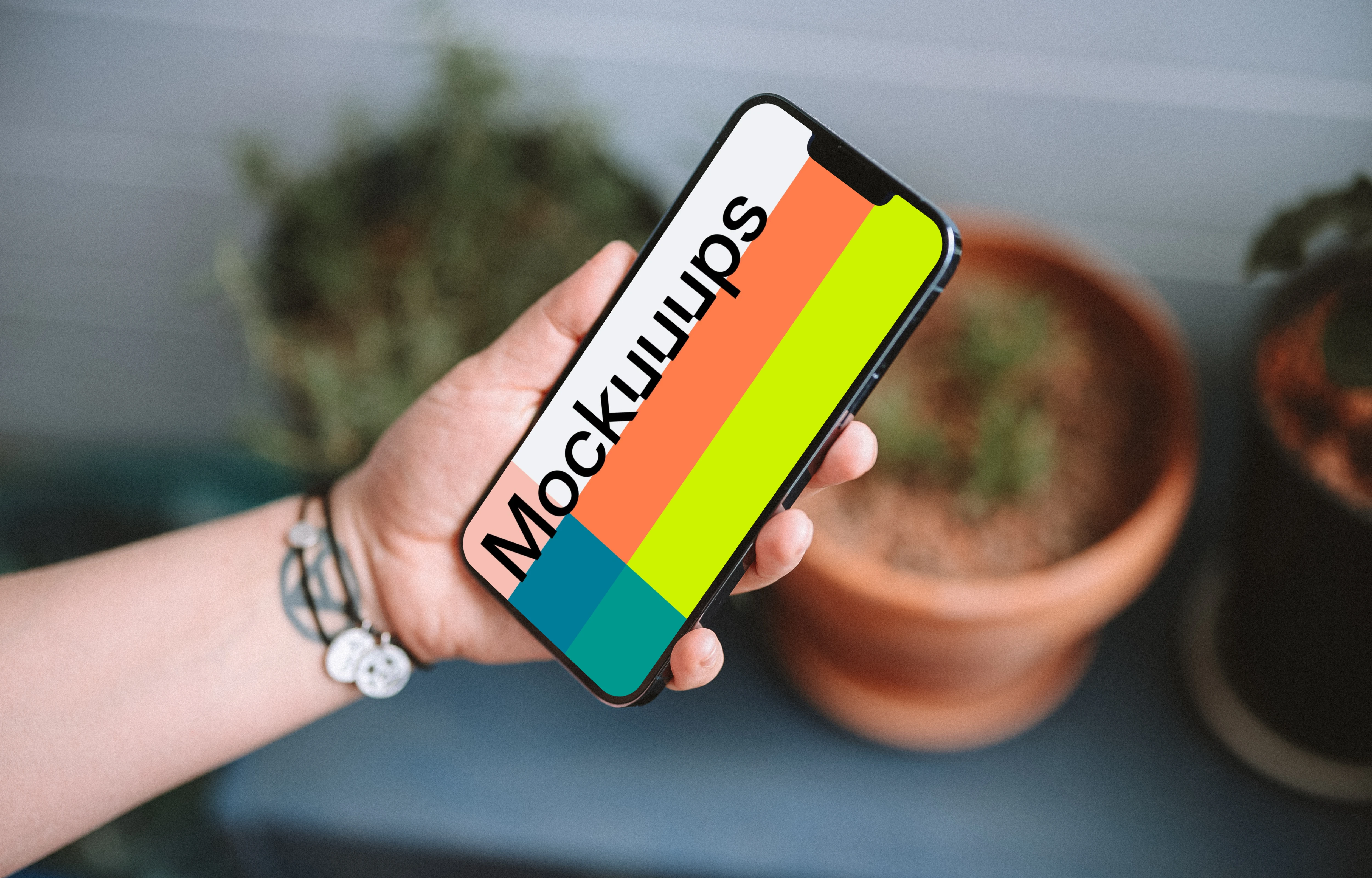 User holding an iPhone 13 mockup