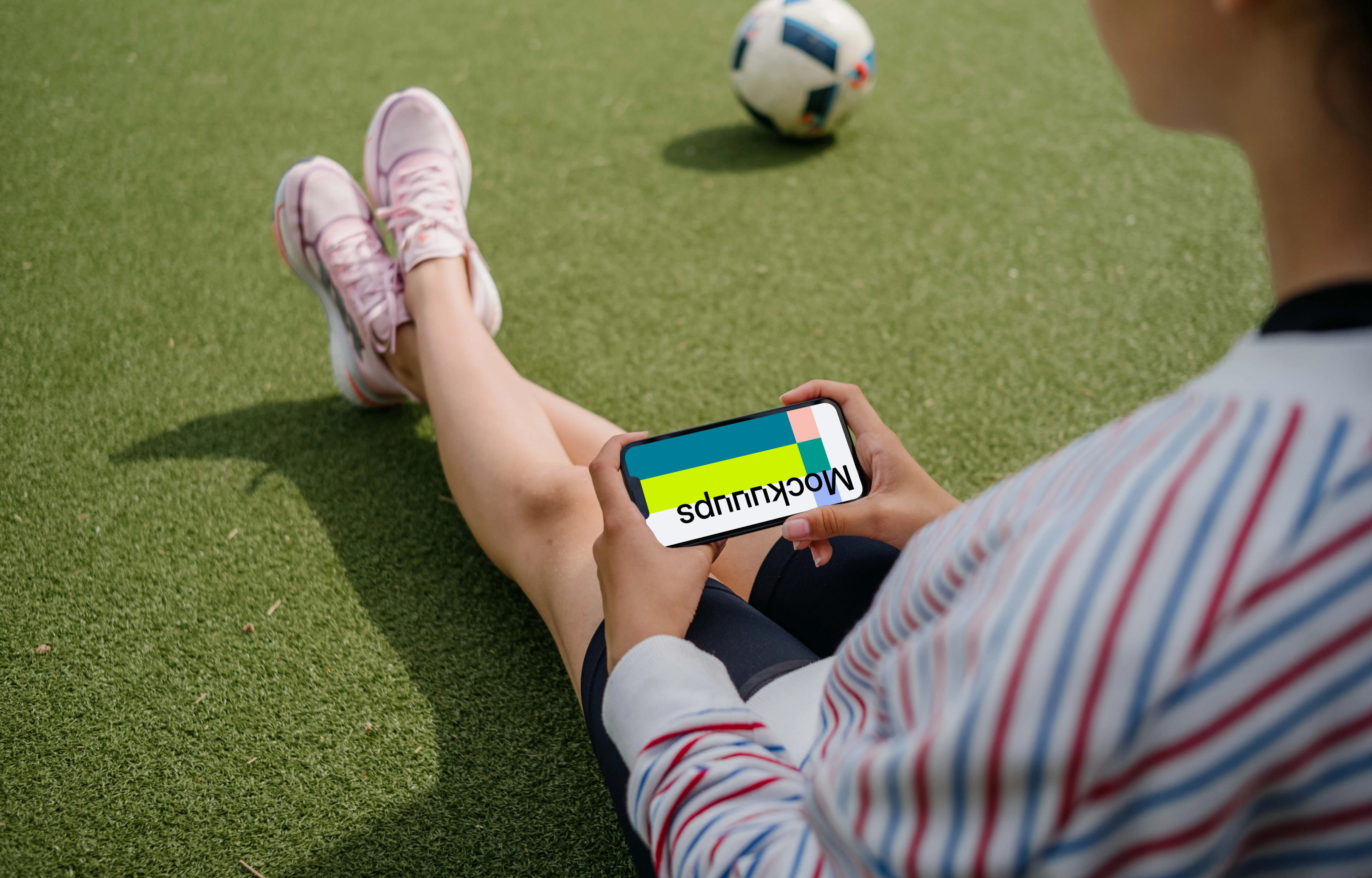 Young woman holding an iPhone mockup