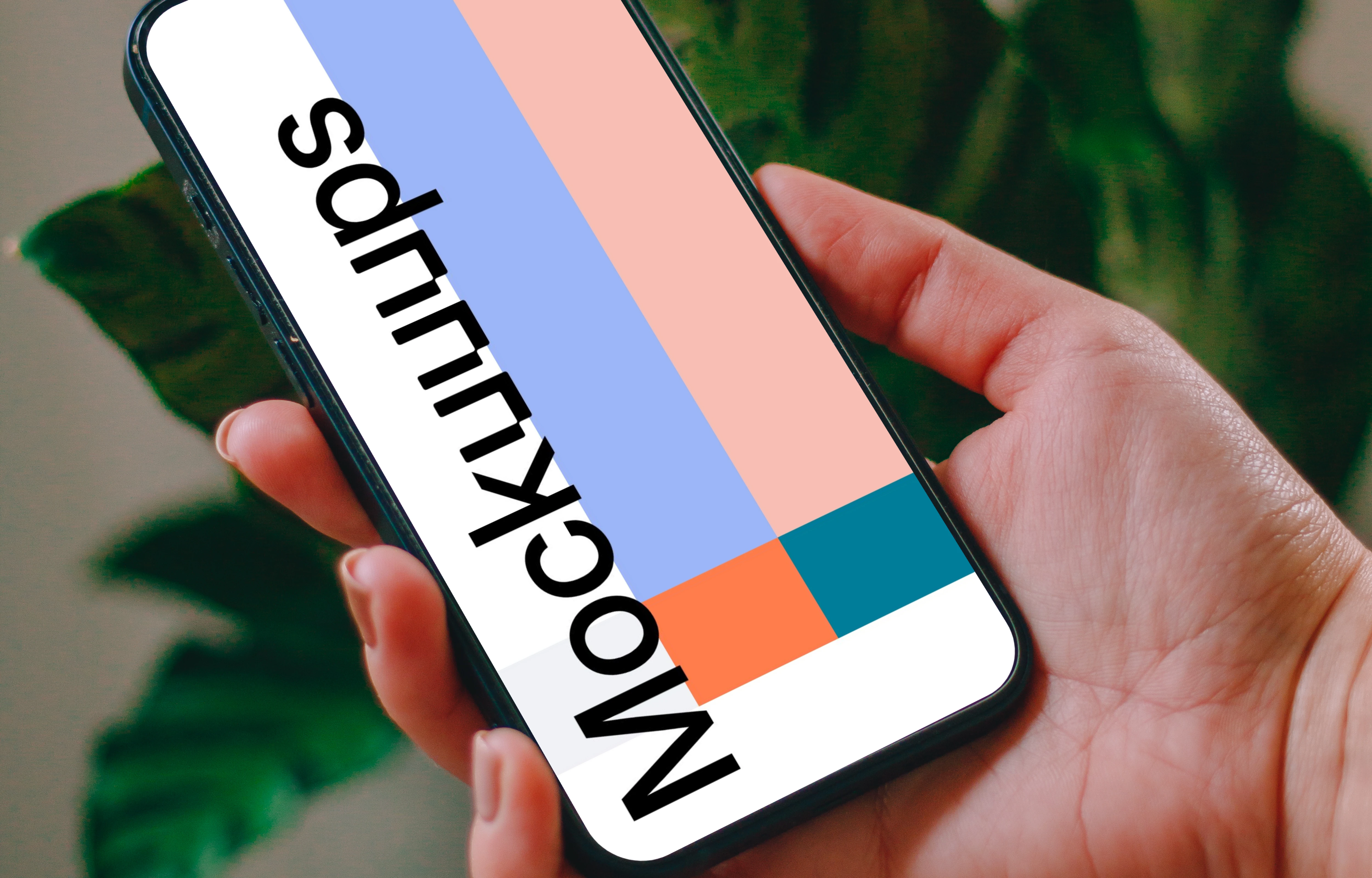 Person holding an iPhone 13 mockup