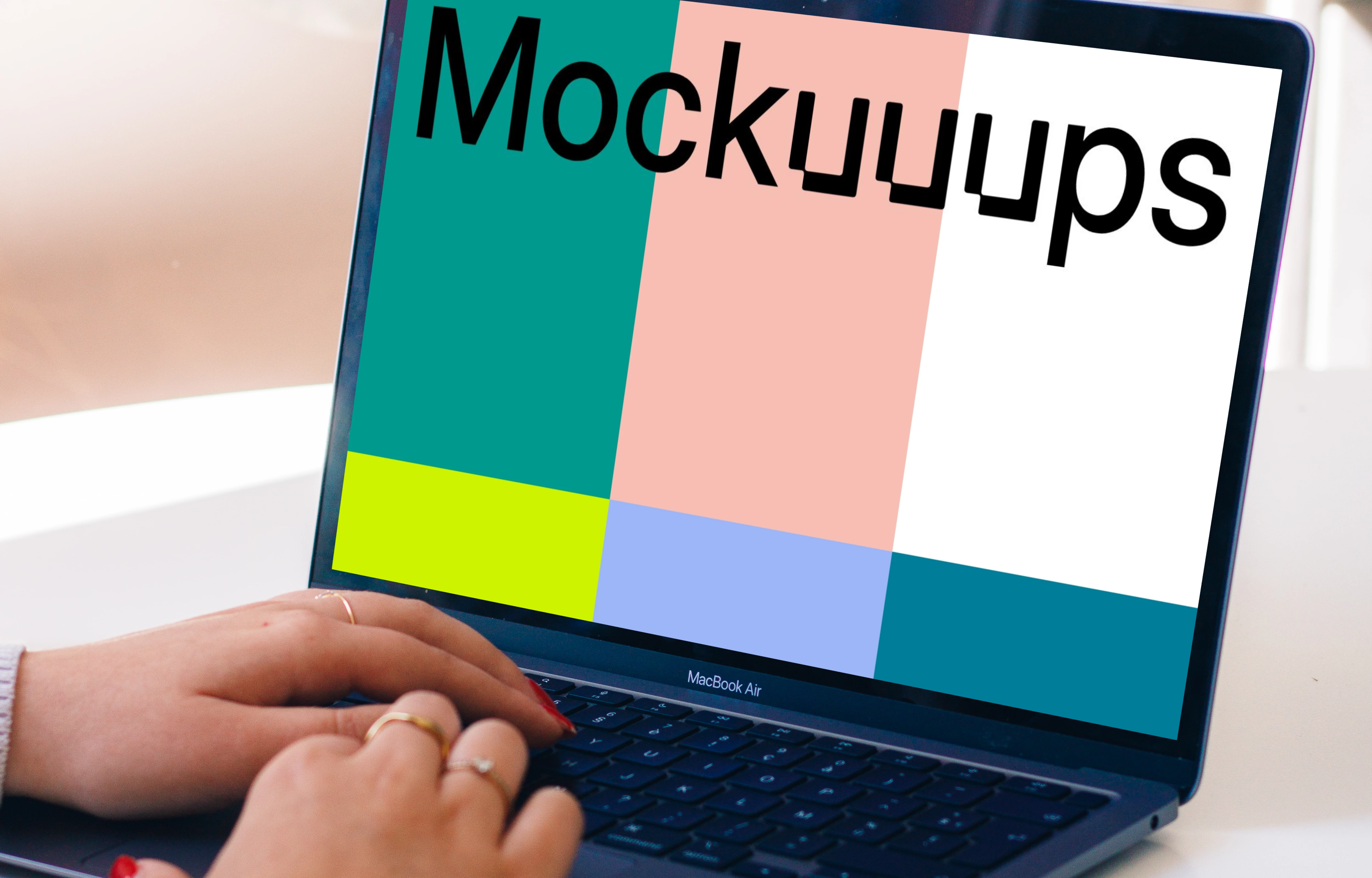 Person typing on a MacBook Air mockup