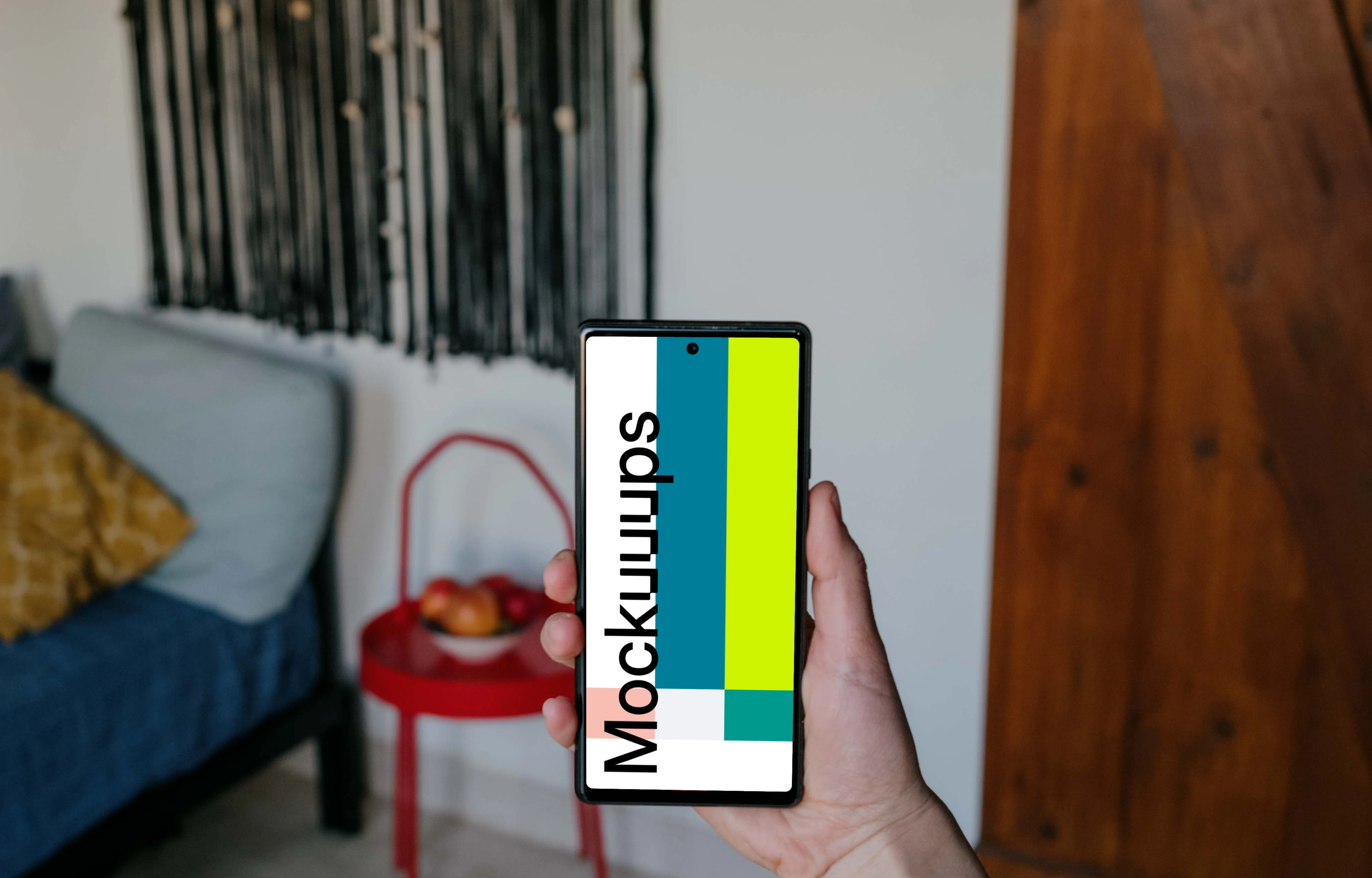 Pixel 6 mockup held by a user in a living room