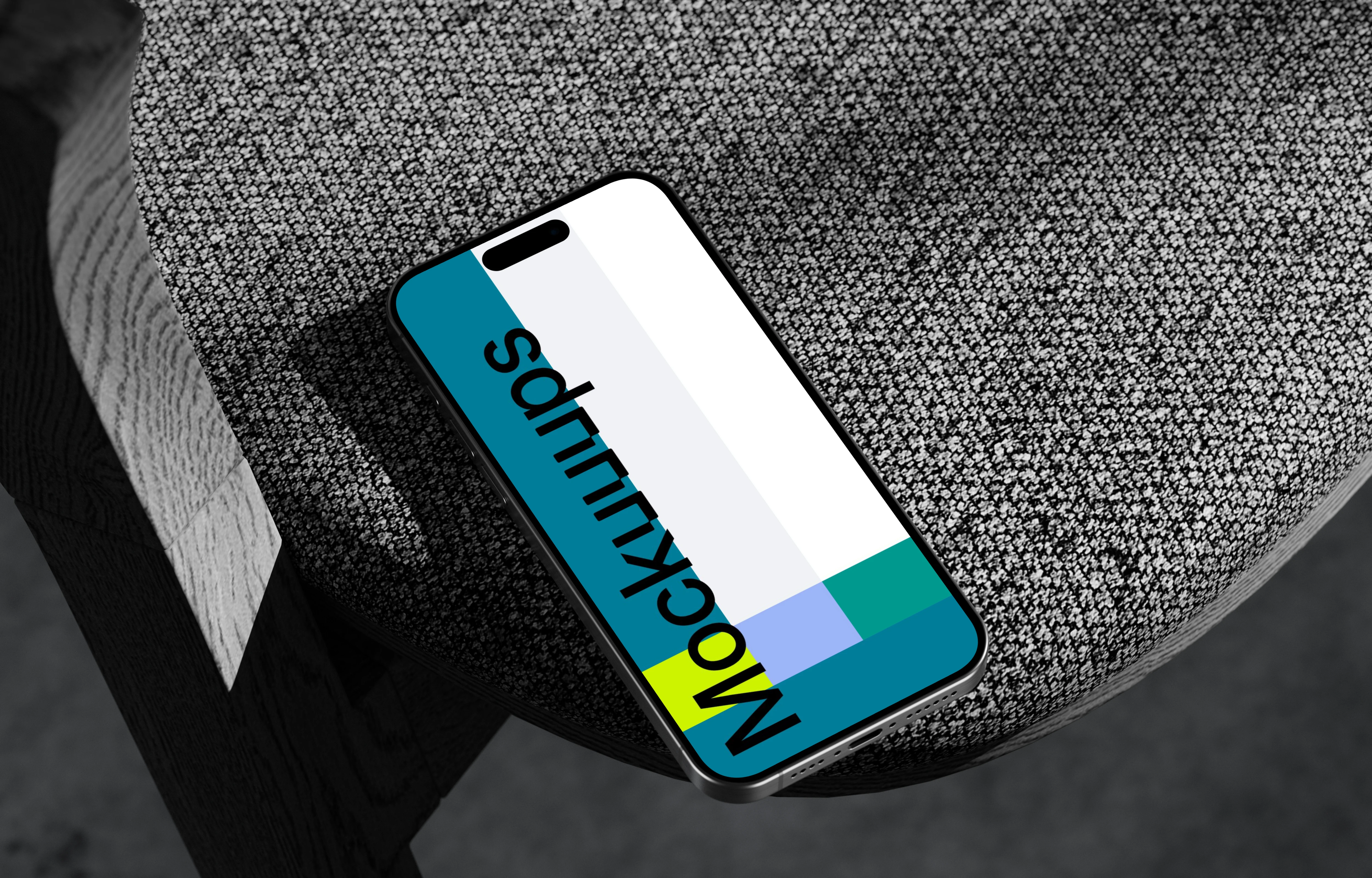 iPhone 15 Pro mockup on textured rock surface with dramatic lighting