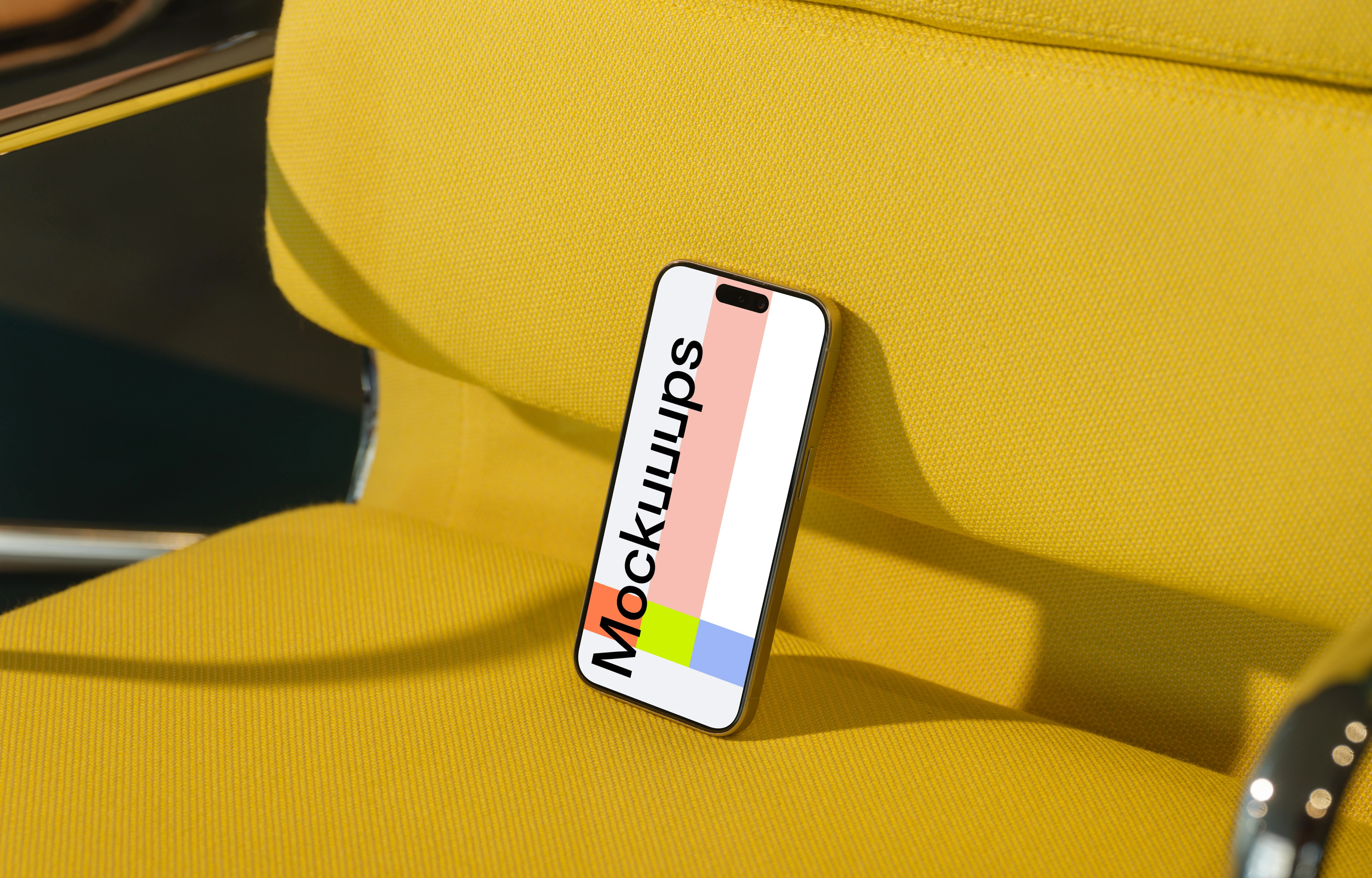 iPhone 15 Pro mockup on yellow armchair