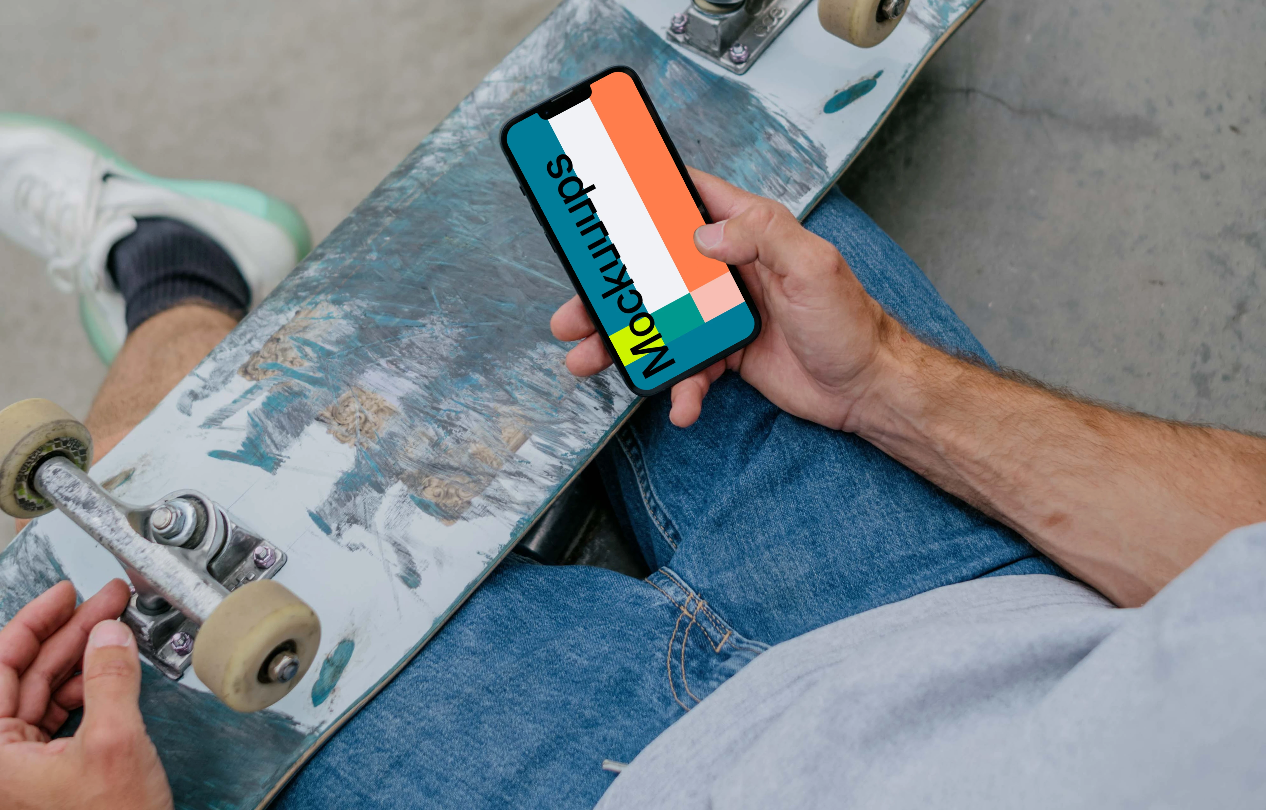 Skateboarder typing on an iPhone mockup