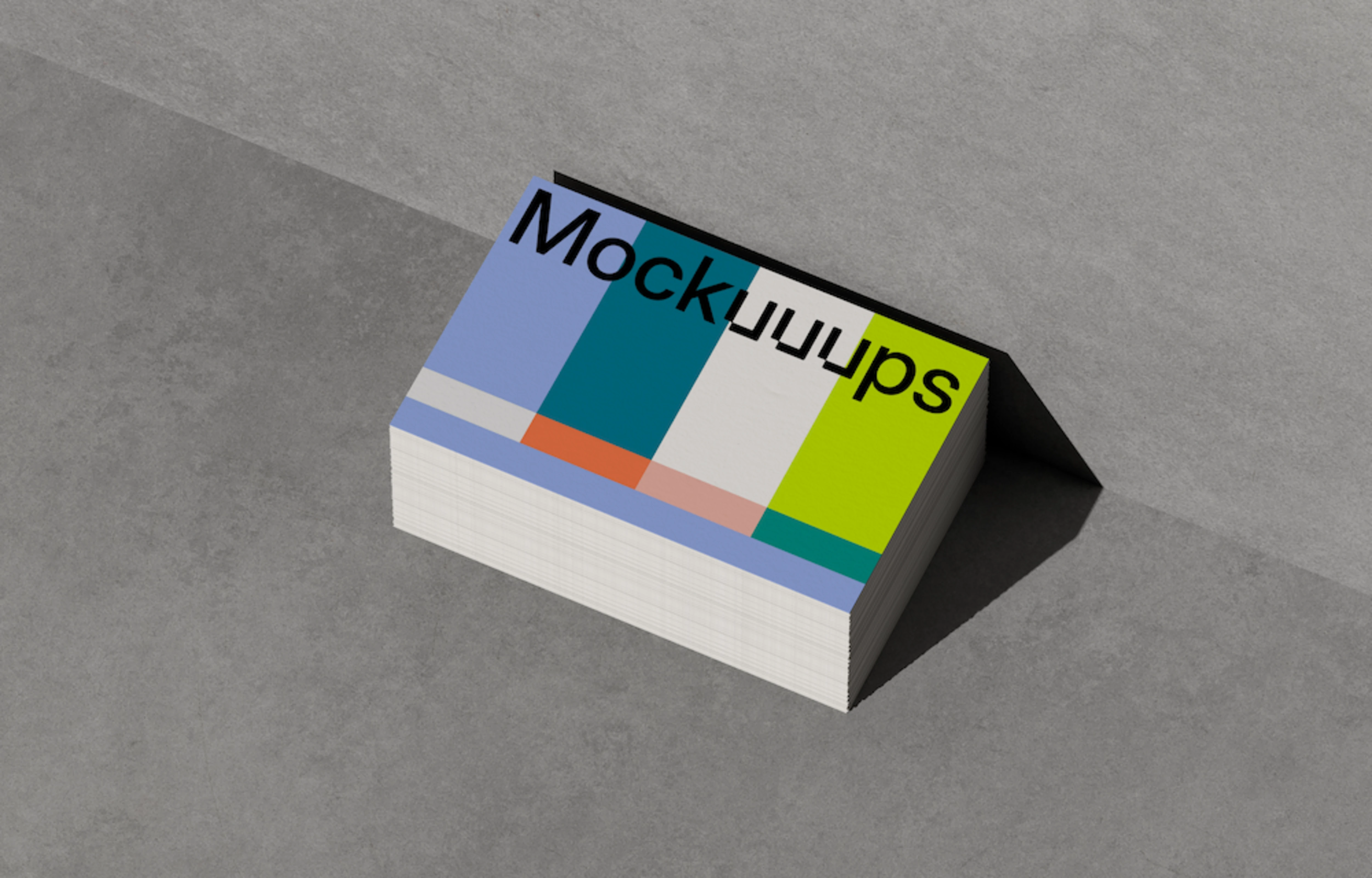 Stack of business card mockups on a textured concrete surface