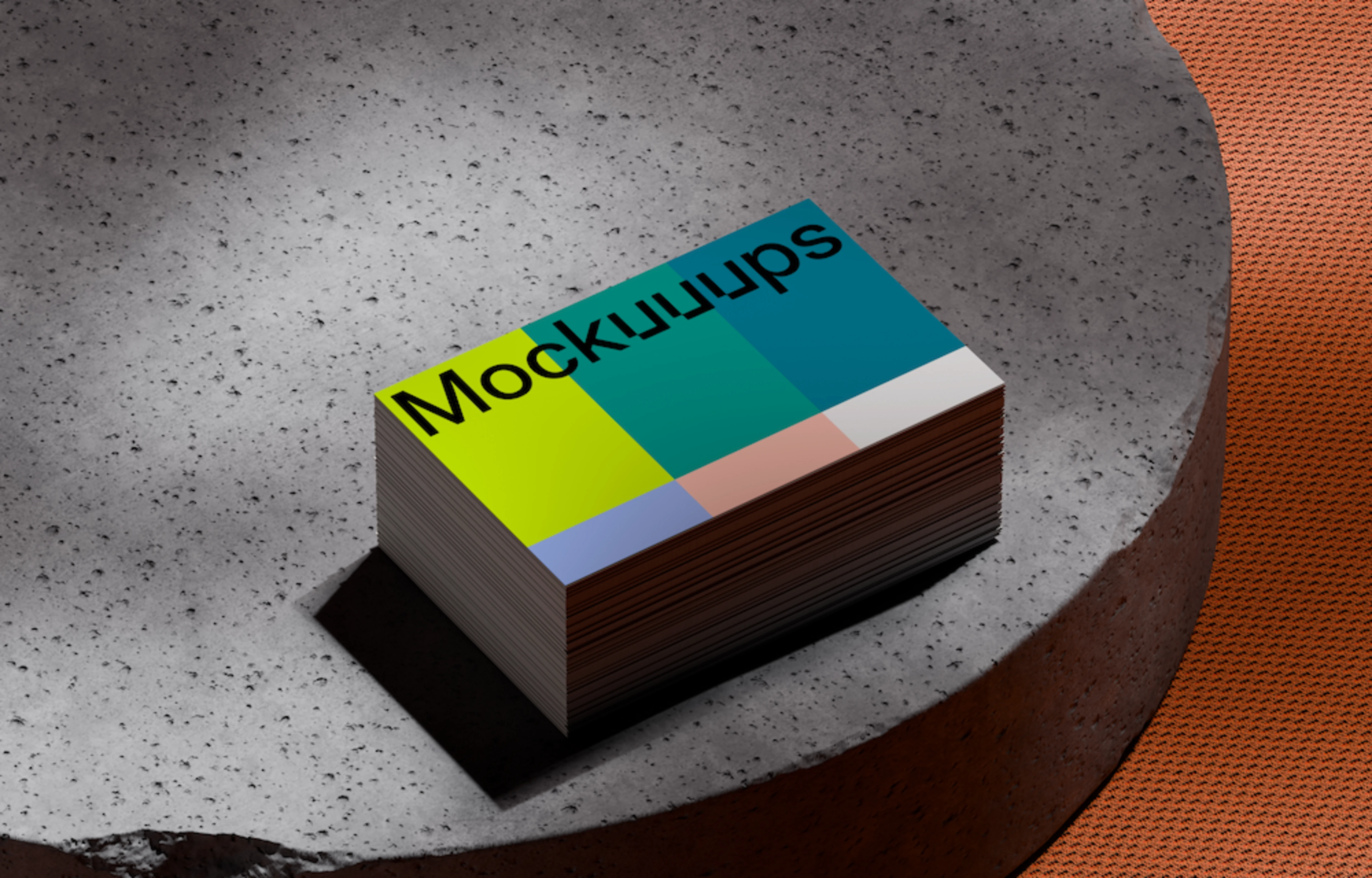Stack of business card mockups on textured concrete platform