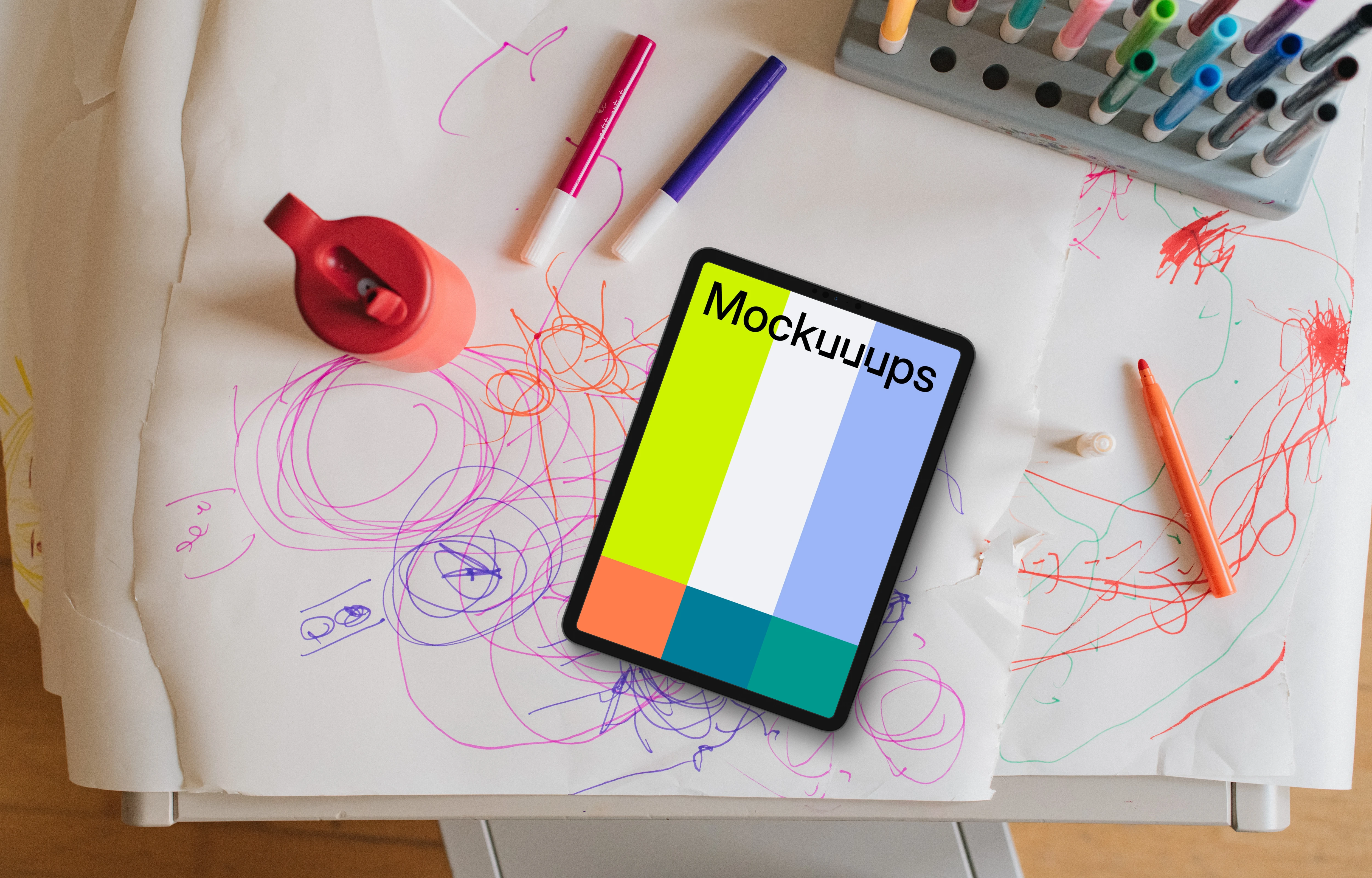 Tablet mockup on a child's drawing table