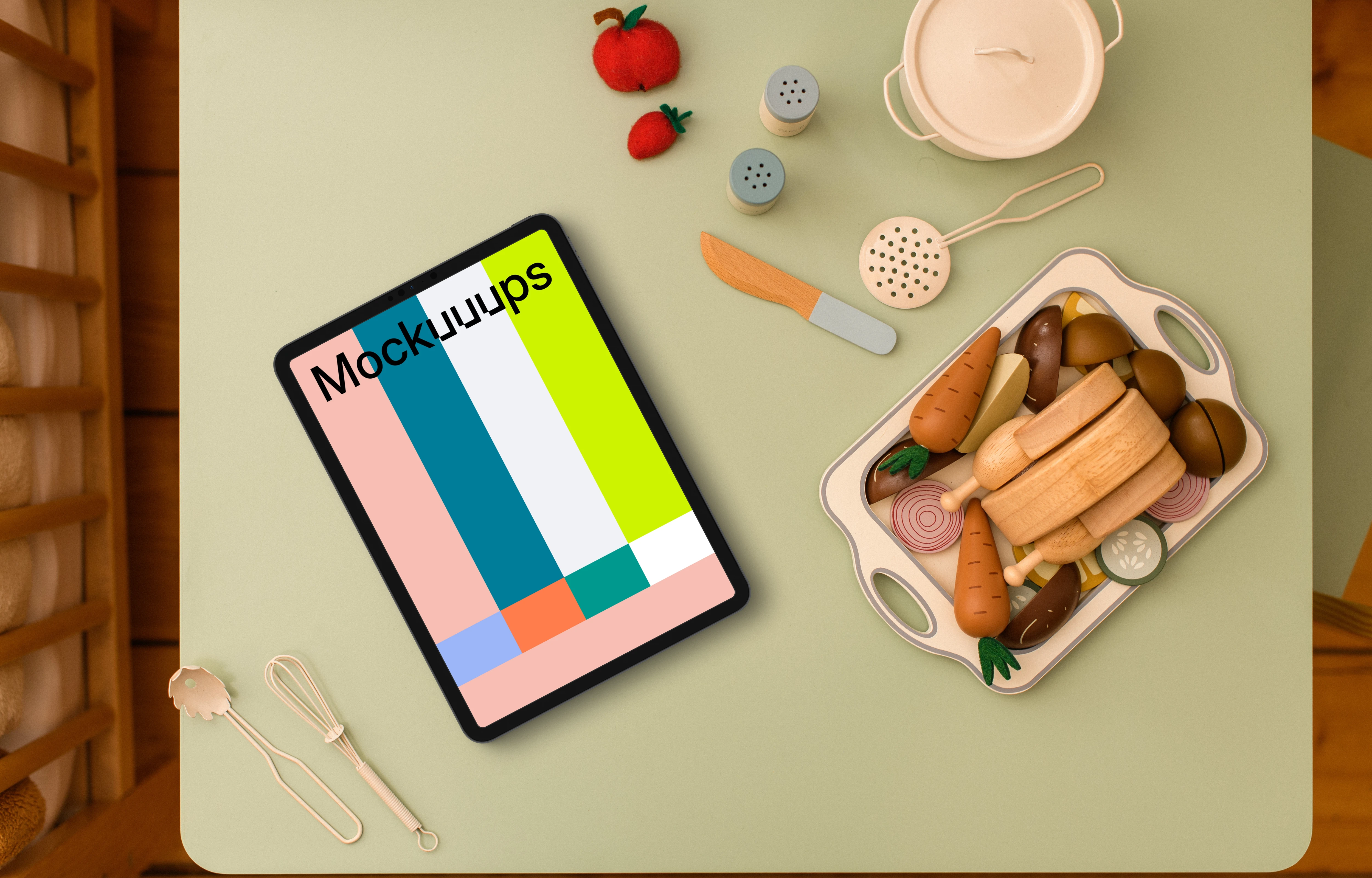 Tablet mockup surrounded by children’s play kitchen set