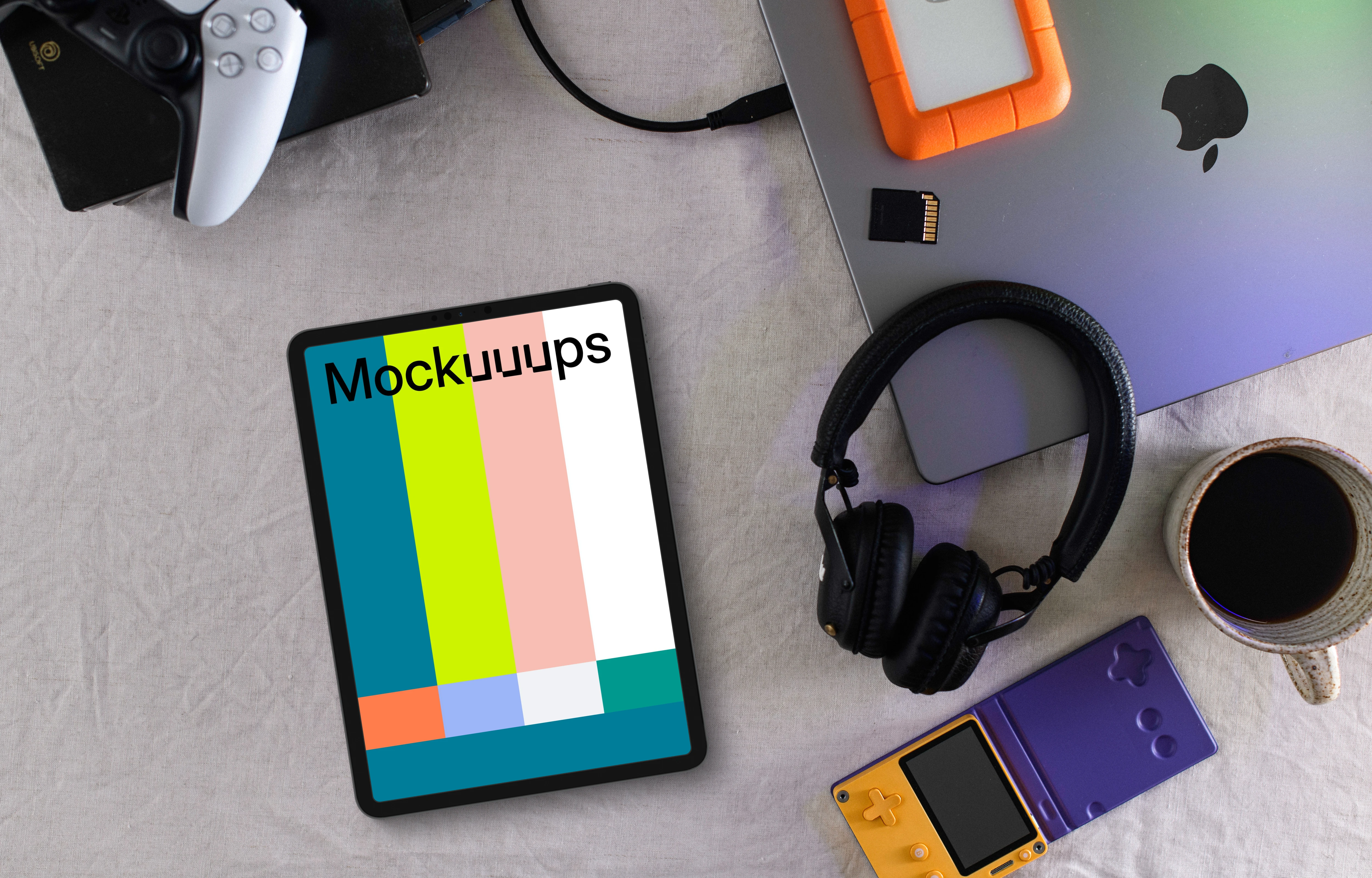 Tablet mockup with gaming devices and laptop on a modern desk