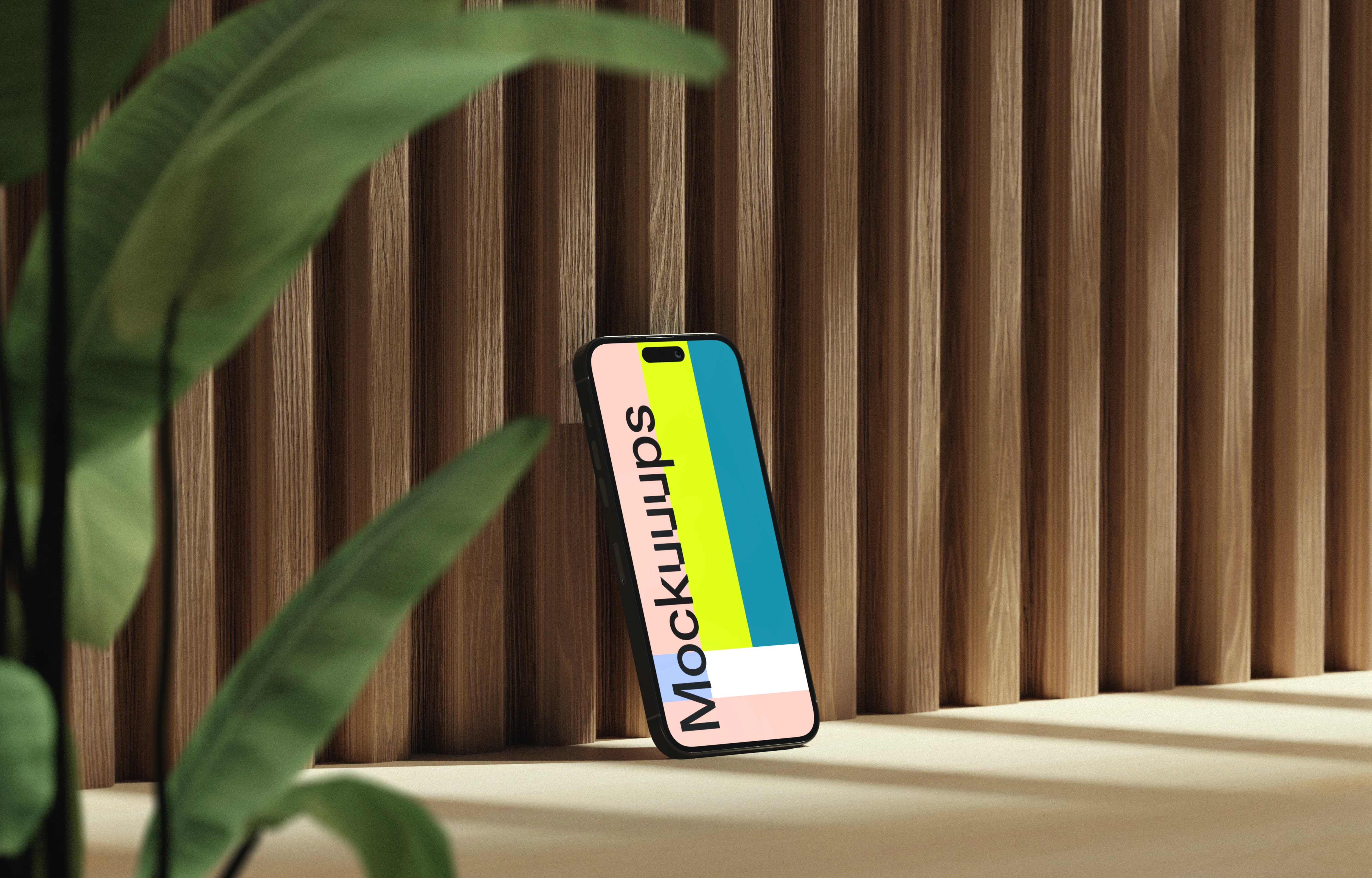 iPhone mockup on a wooden surface with a plant
