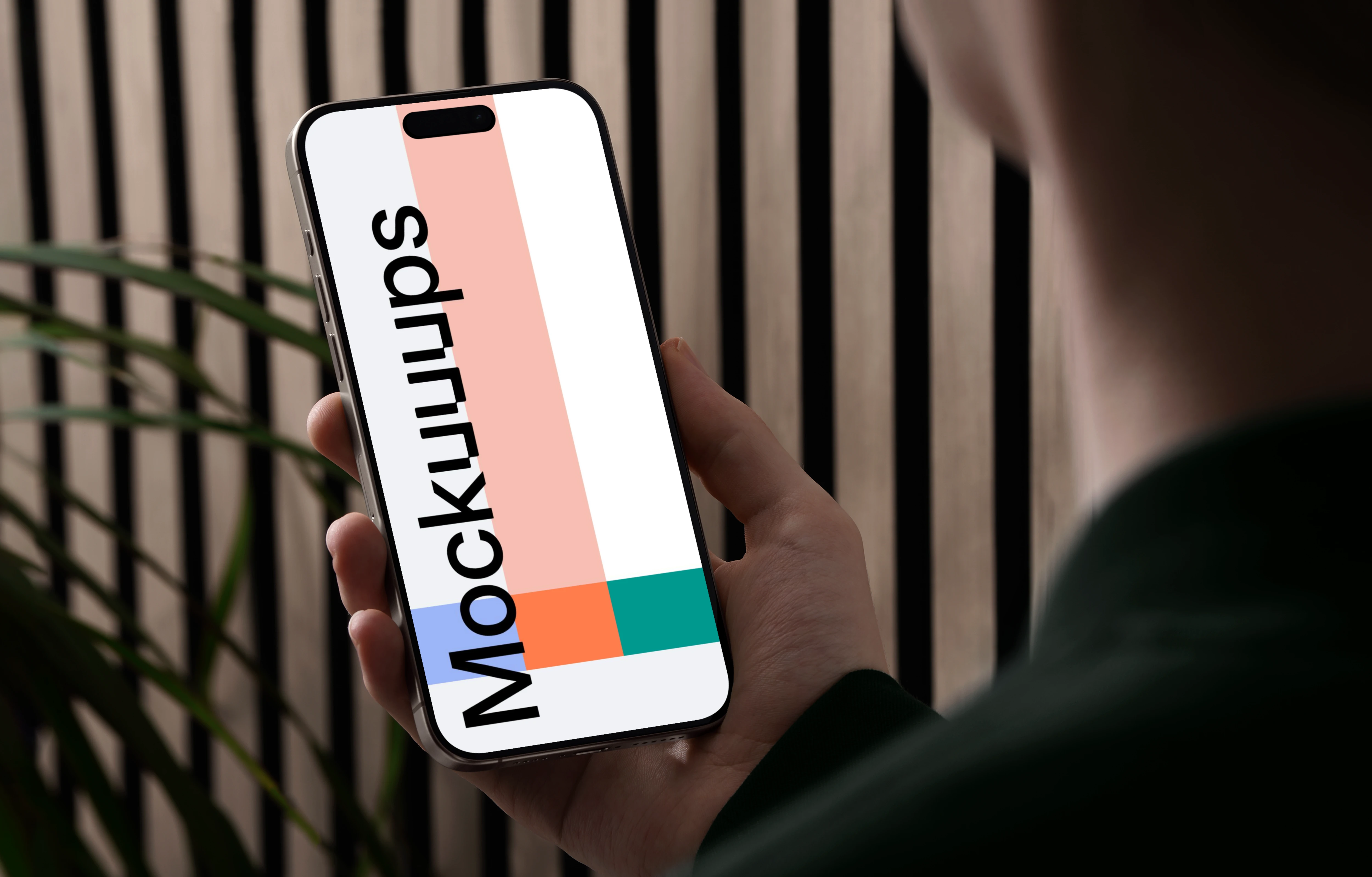 iPhone 15 Pro mockup in a male hand against a modern backdrop
