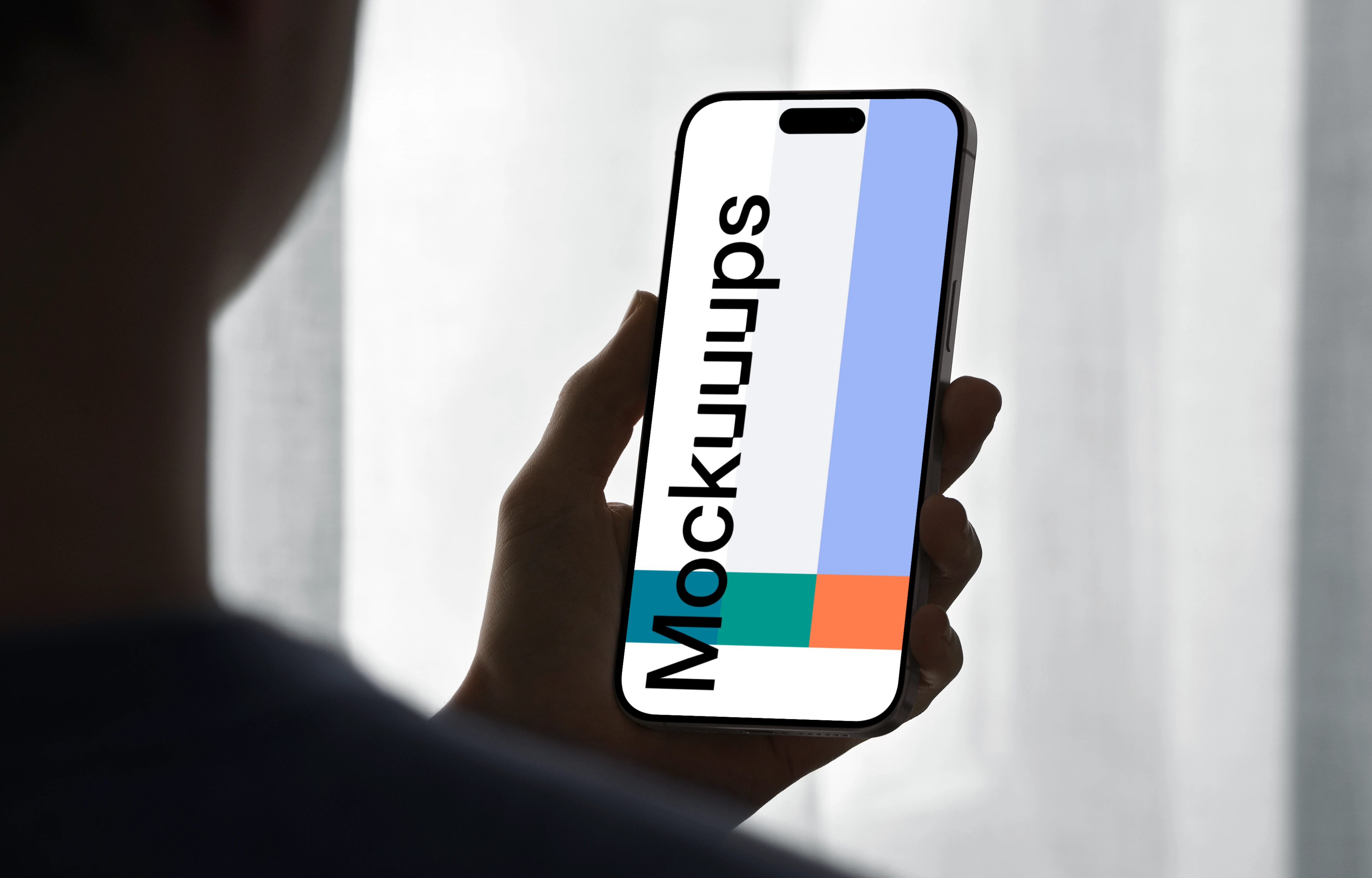 iPhone 15 Pro mockup in a male hand against soft backlight