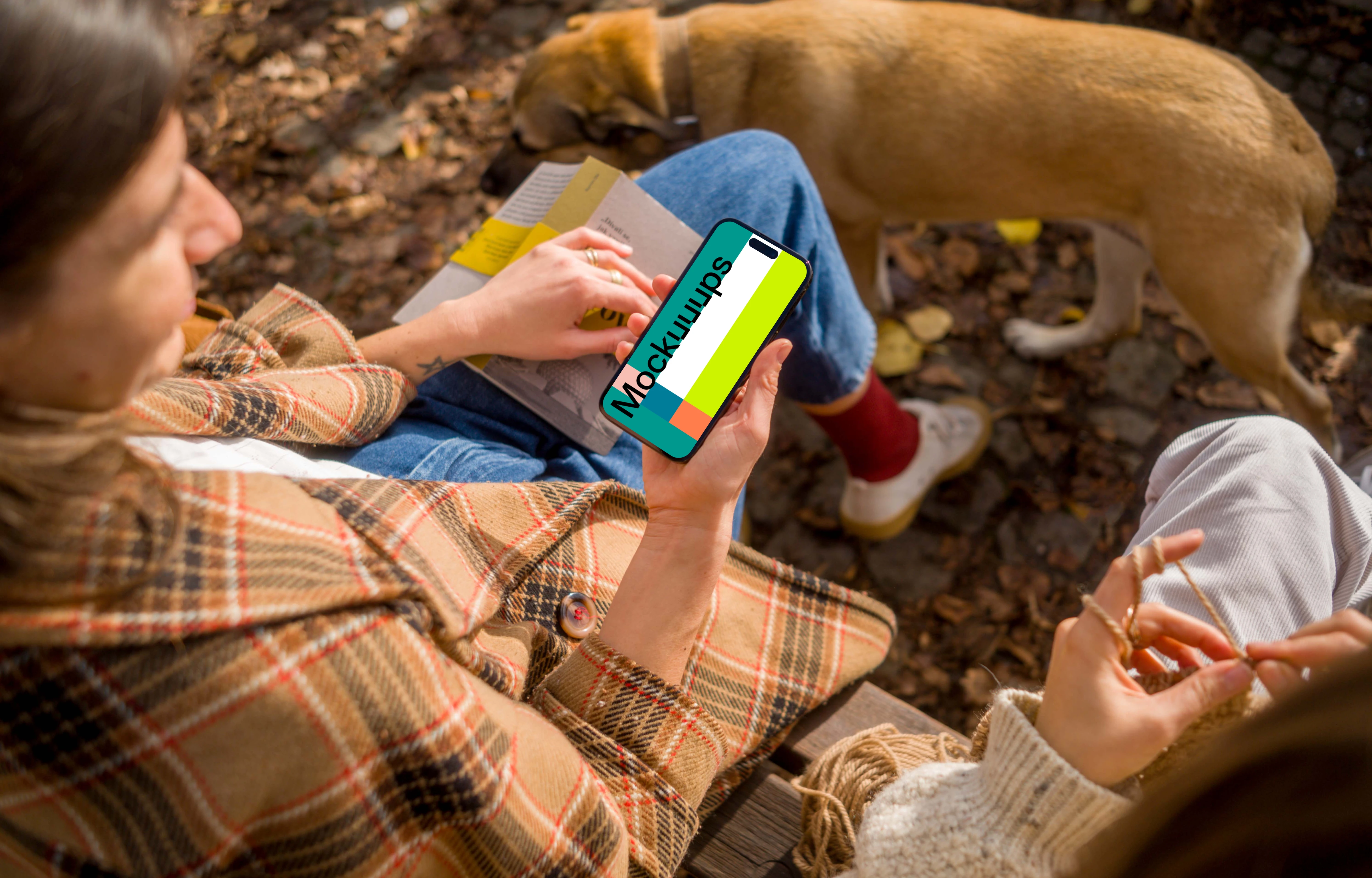 Woman holding an iPhone 14 near dog mockup
