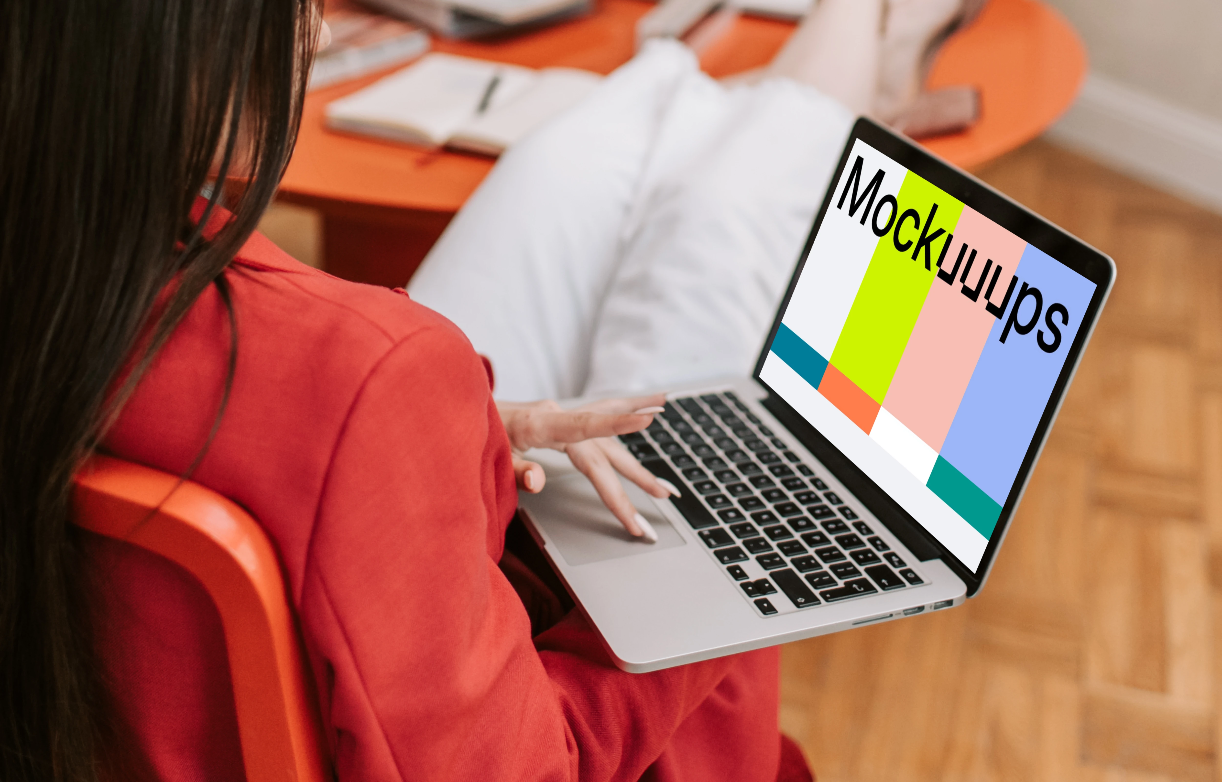 Woman holding a MacBook Pro mockup
