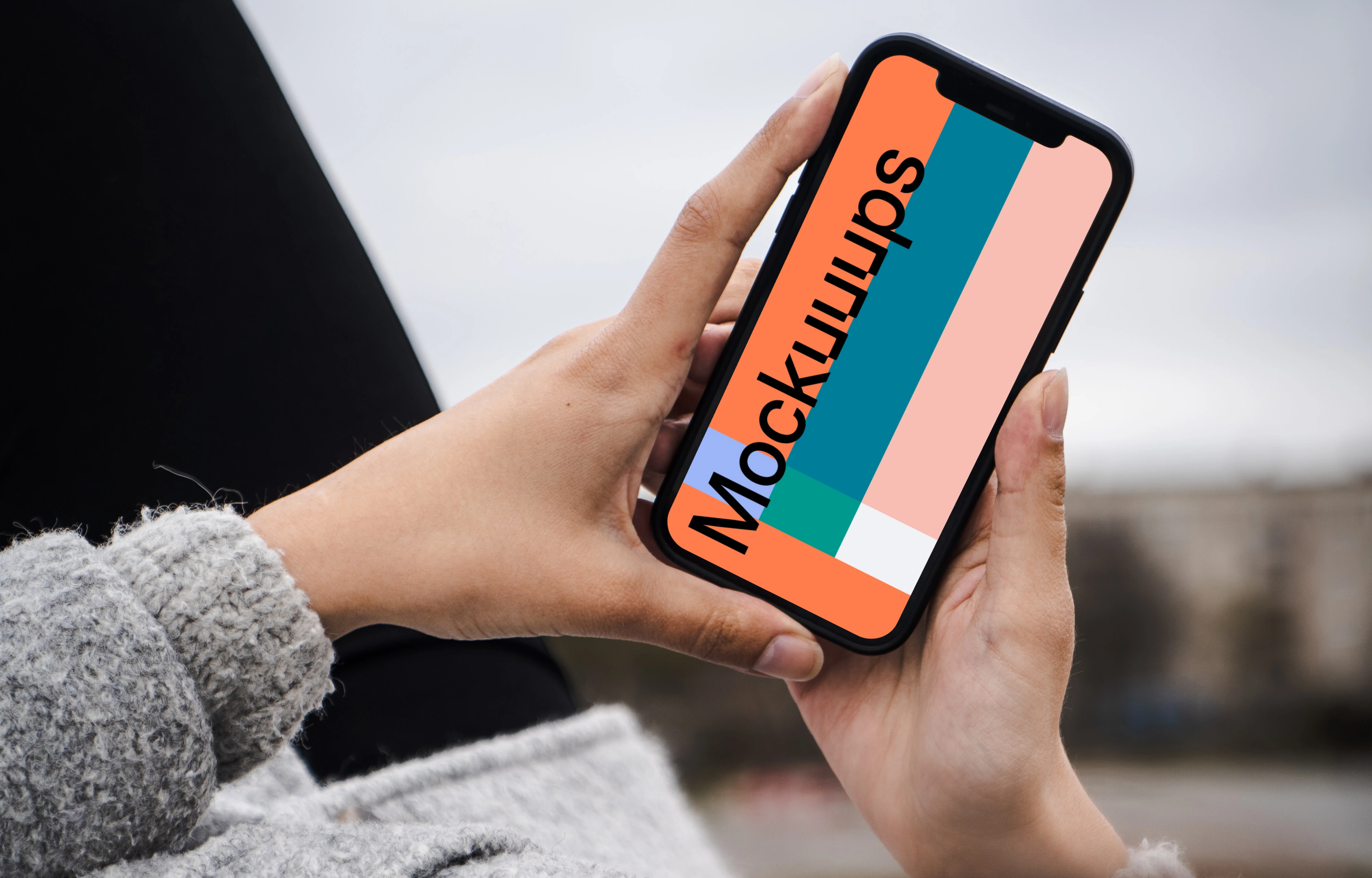 Woman holding a phone mockup in both hands