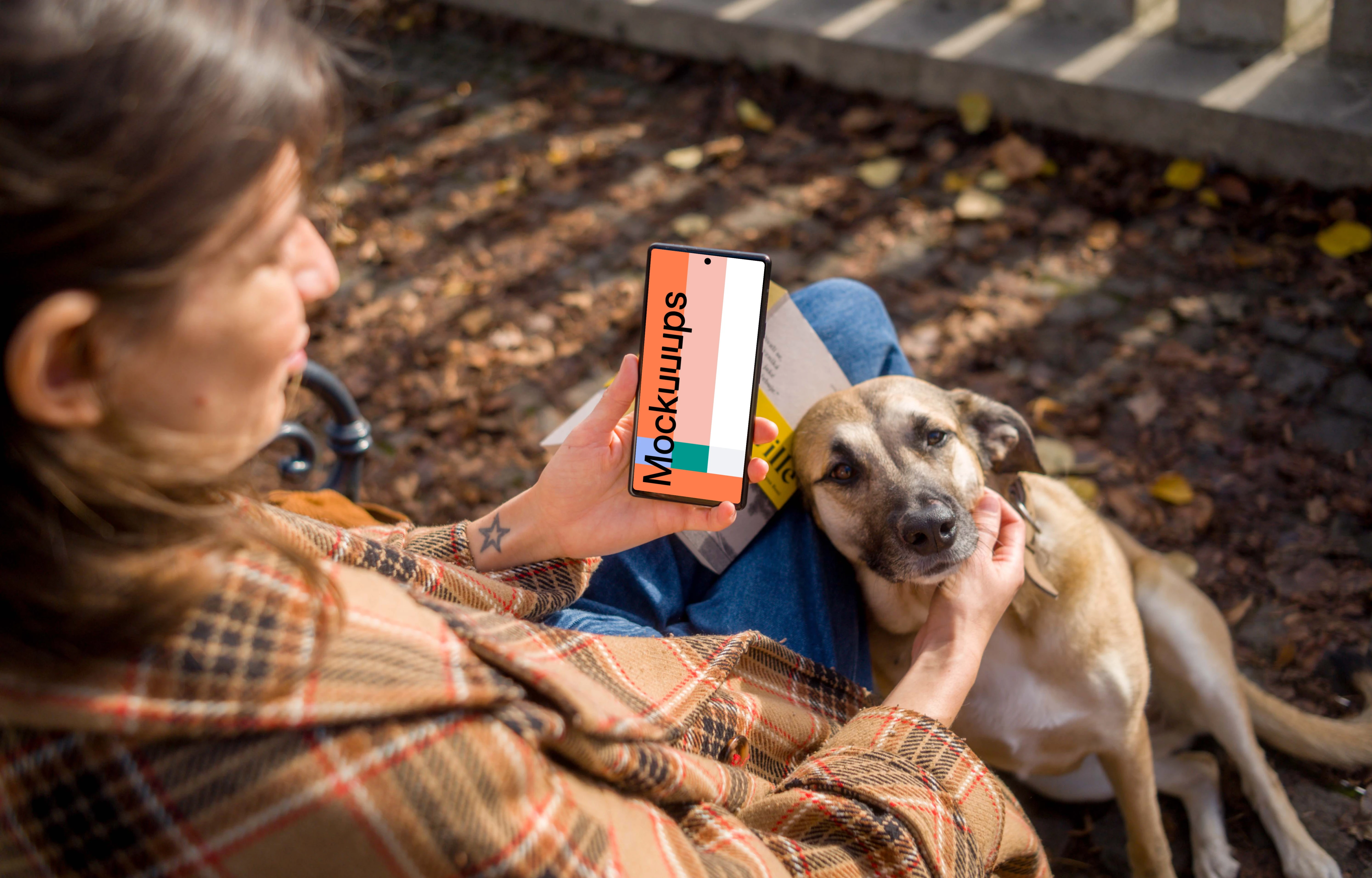 Woman holding a phone while scratching the dog mockup