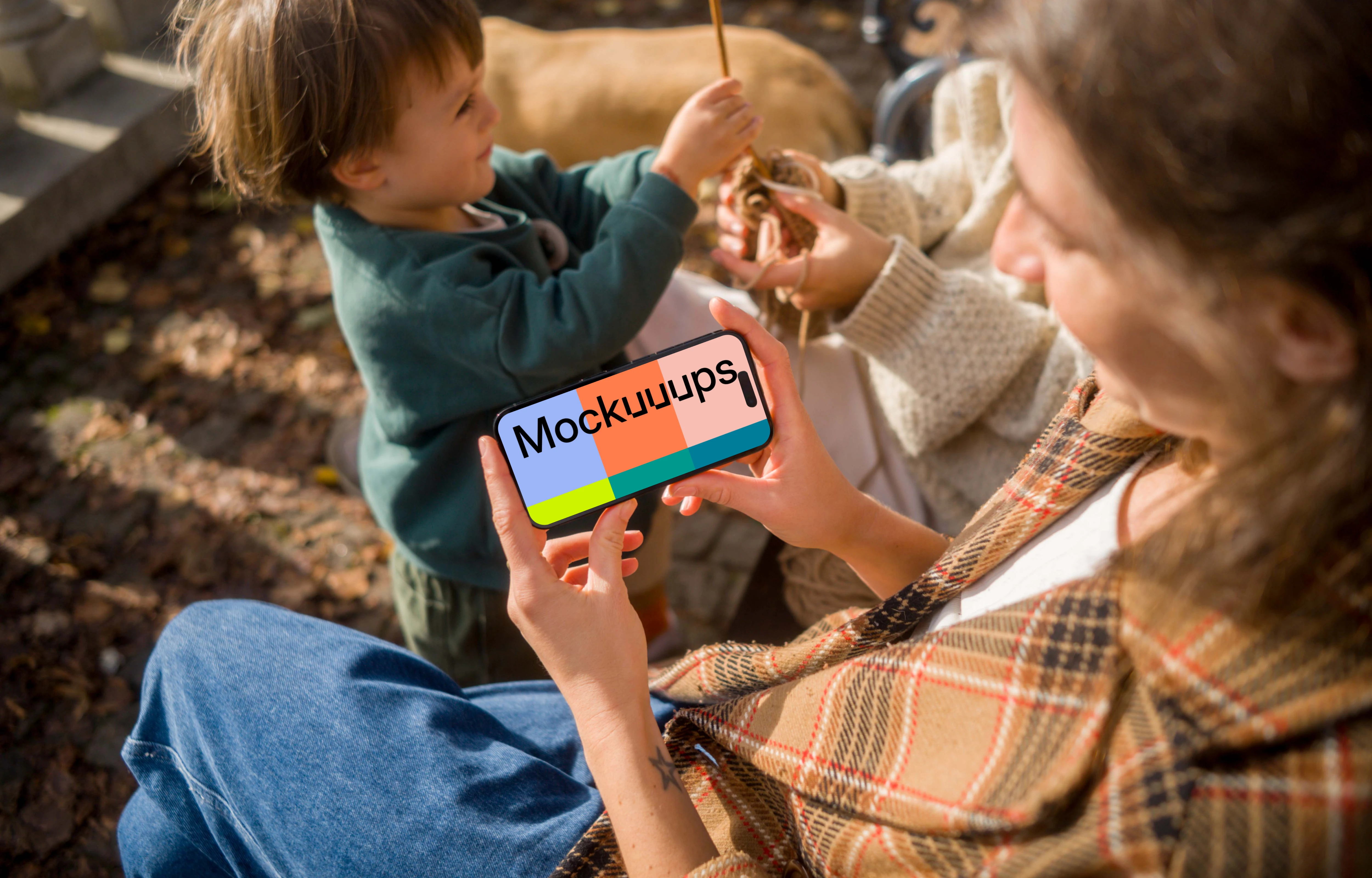 Woman holding an iPhone 14 Pro while sitting on a bench mockup