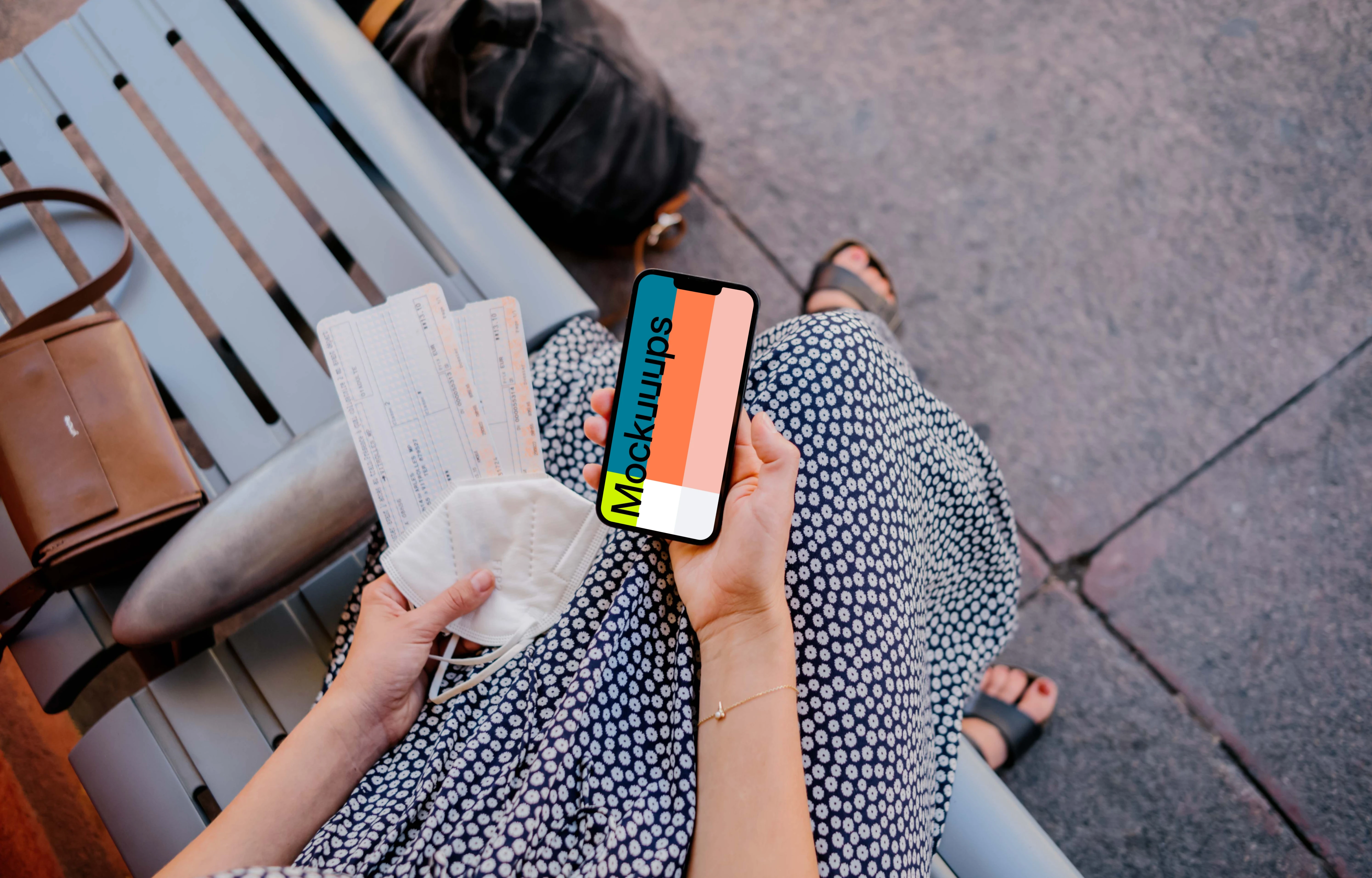 Woman holding iPhone mockup and train tickets