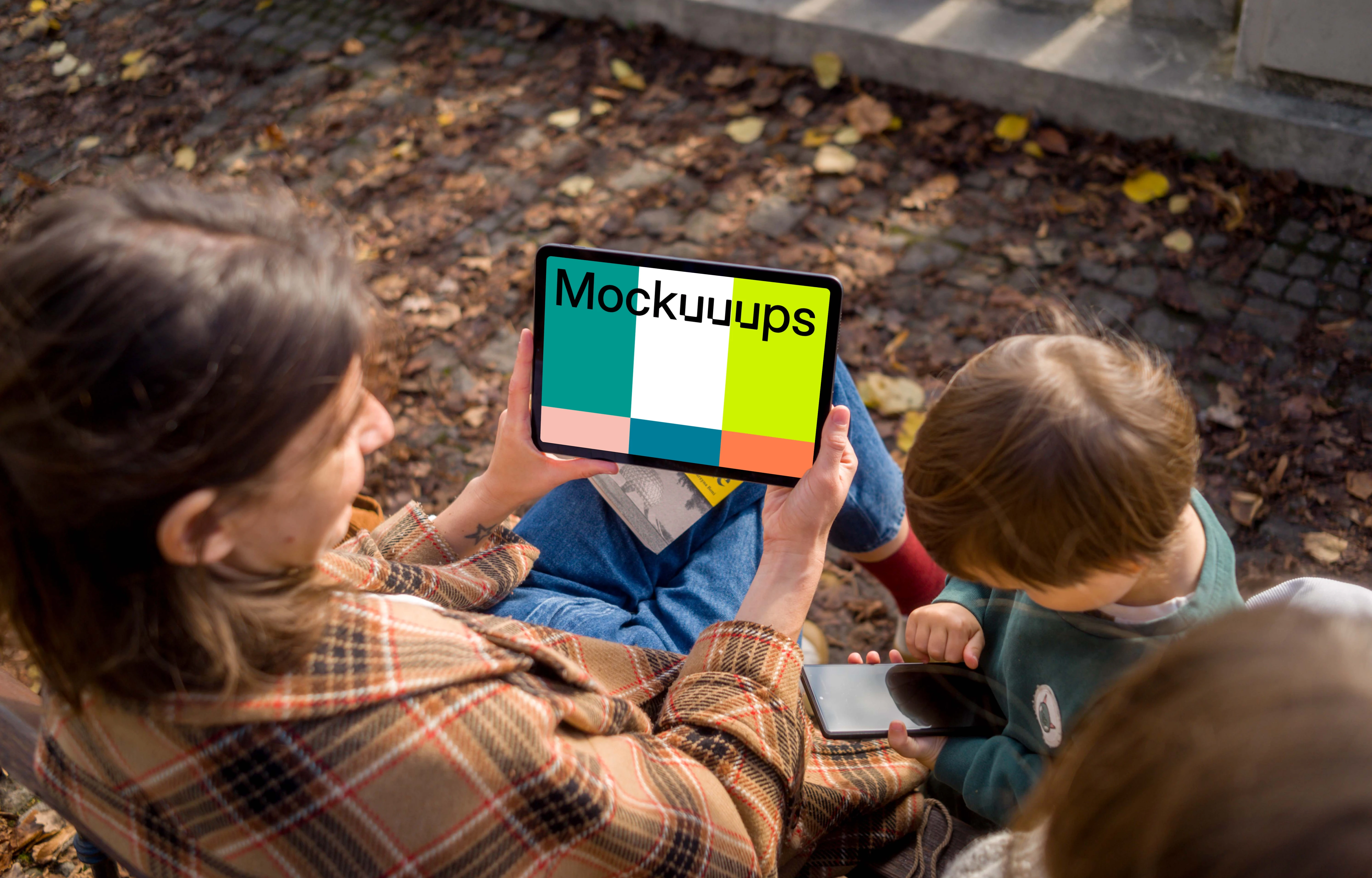 Woman near kids holding an iPad Air mockup