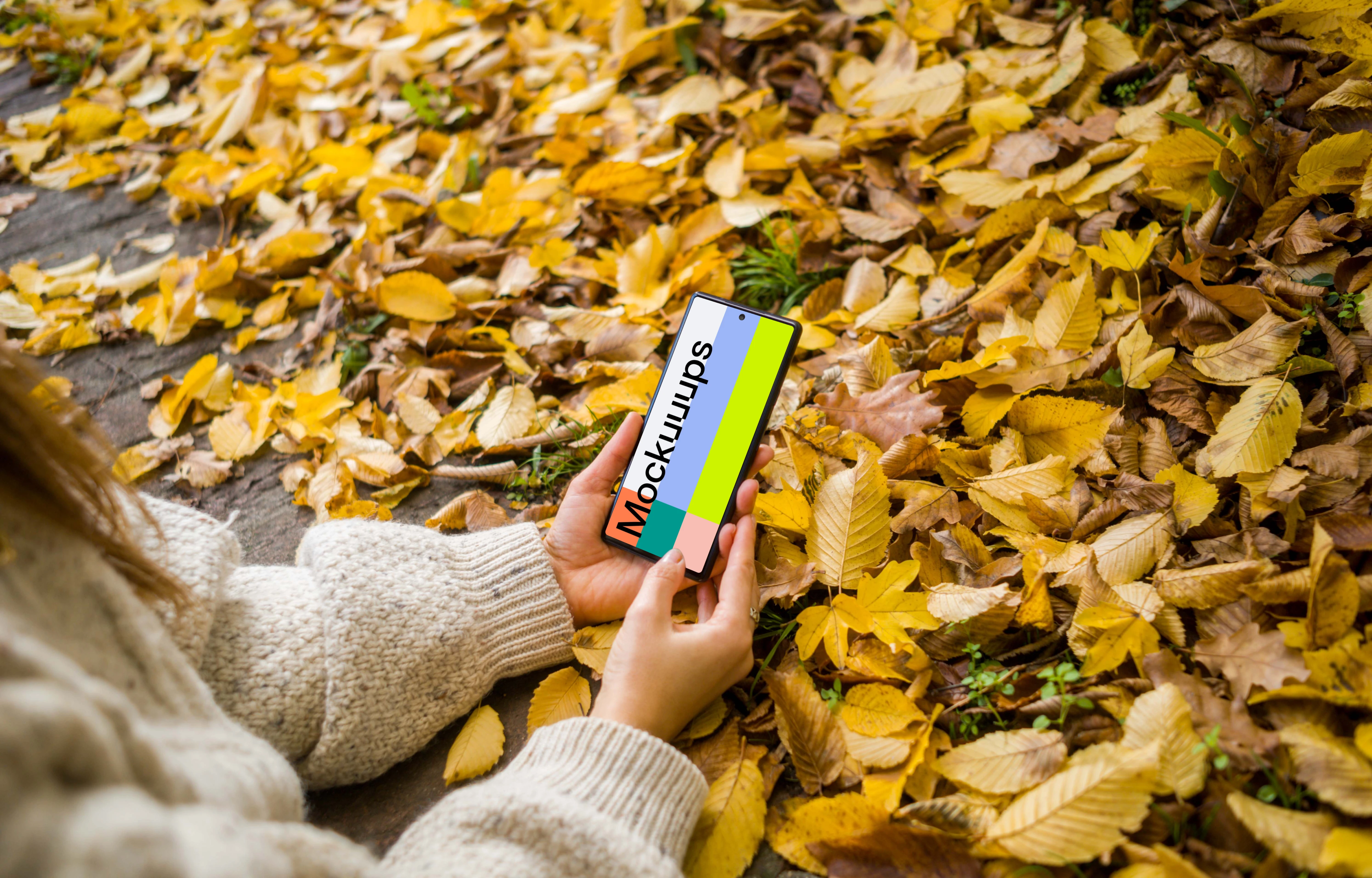 Woman typing on a Google Pixel with autumn styling mockup