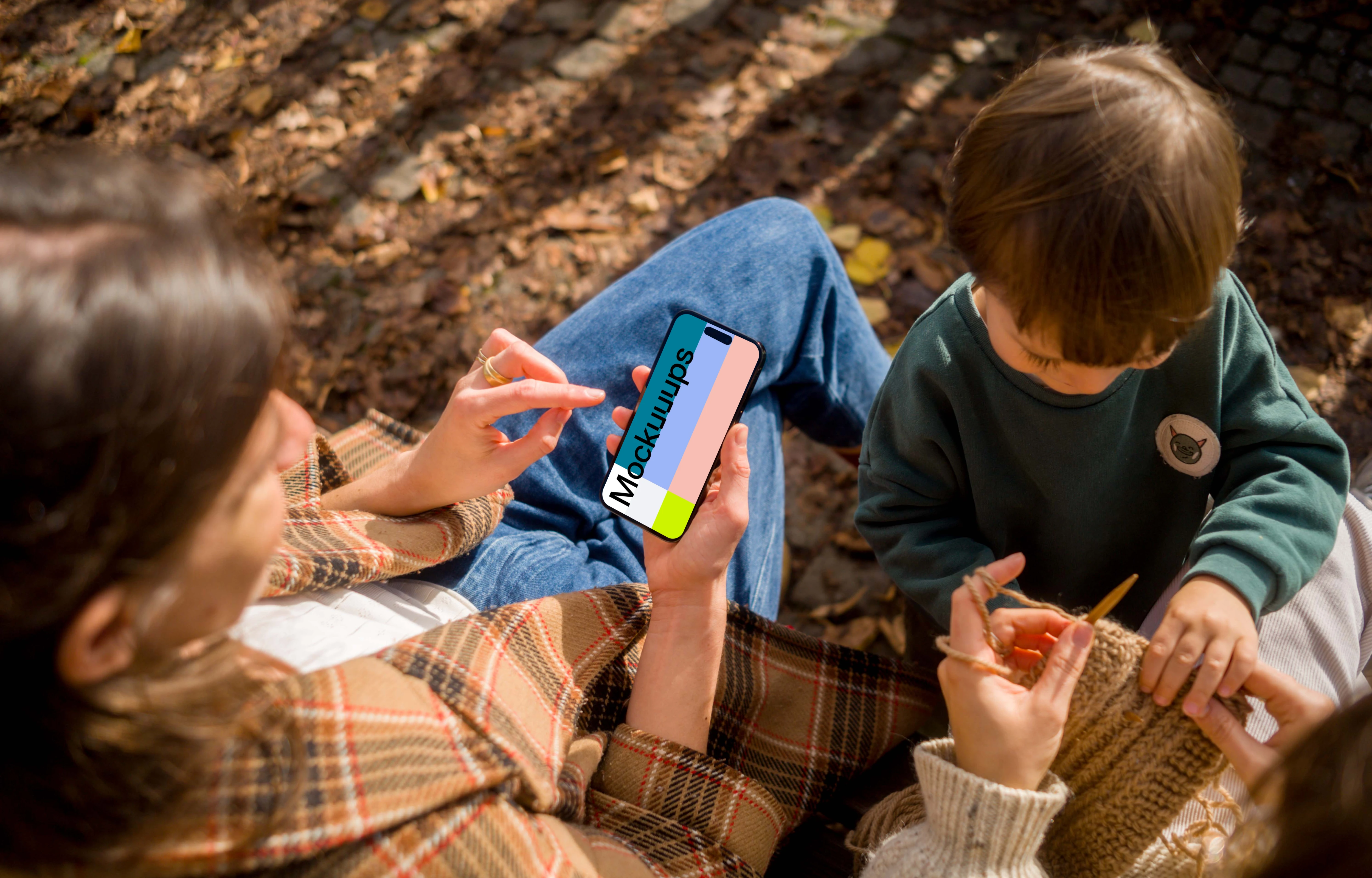 Woman typing on an iPhone 14 Pro next to the kid mockup