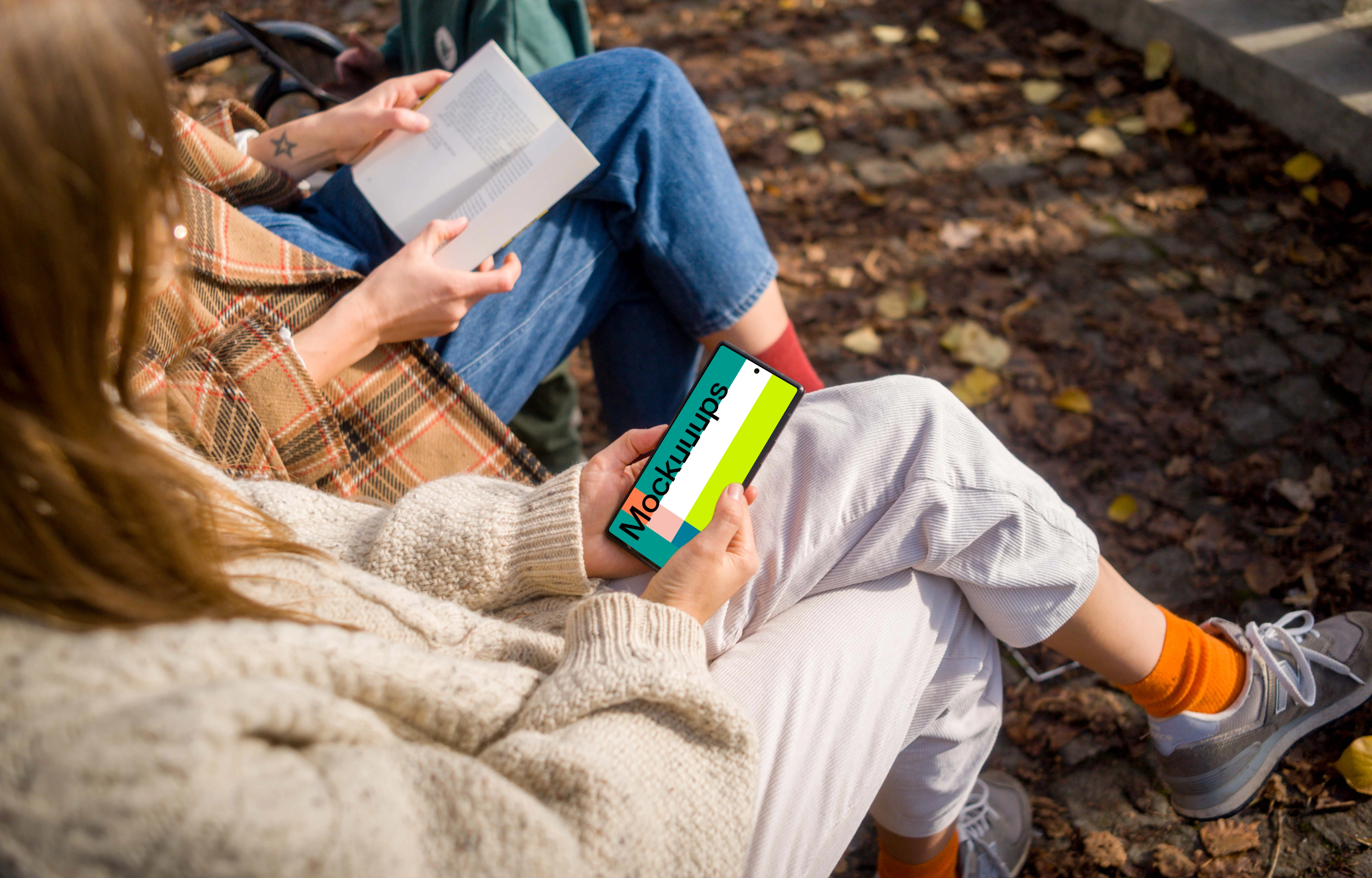 Woman holding a Google Pixel 6 in autumn park mockup