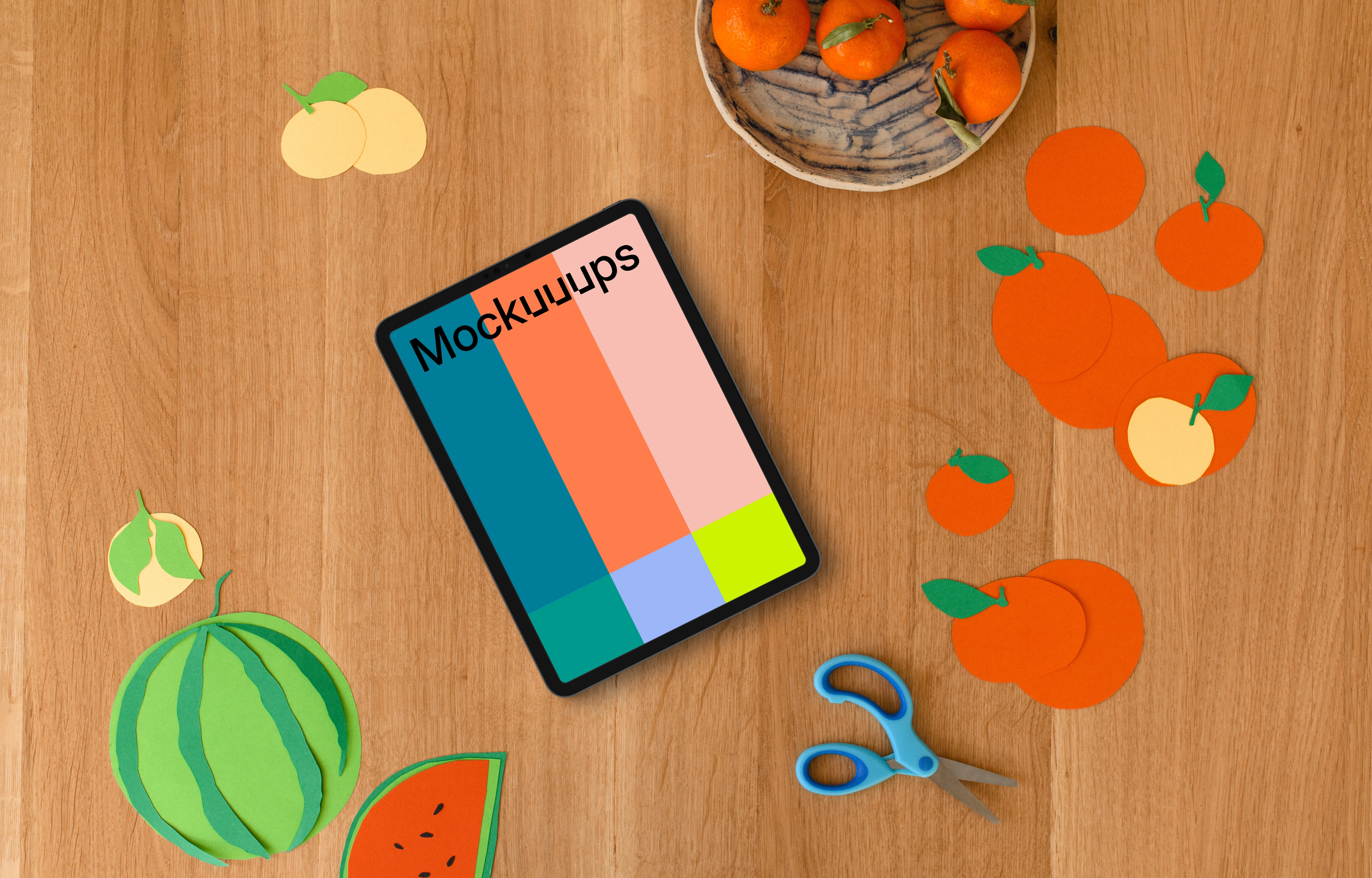 Tablet mockup surrounded by colorful paper fruit cutouts