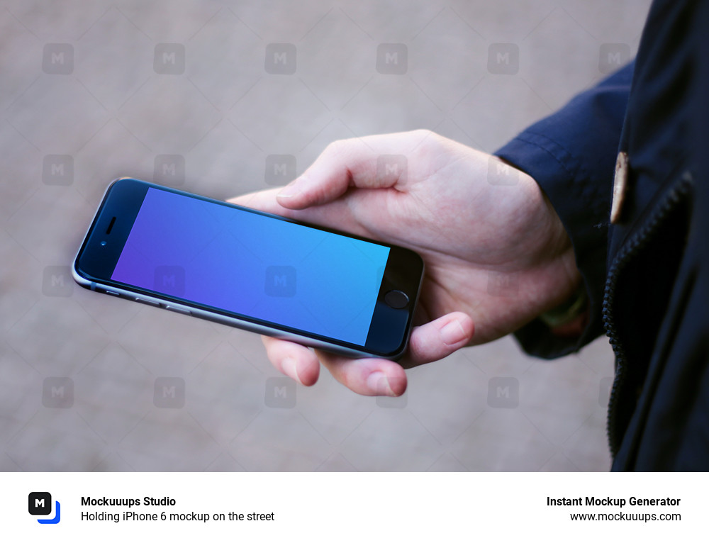 Holding iPhone 6 mockup on the street